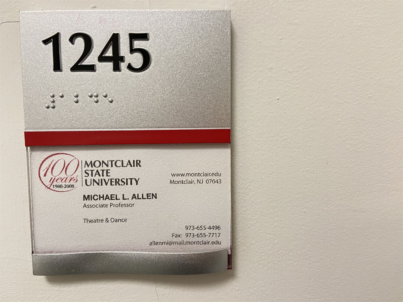 Professor Allen's business card next to his office room number. John LaRosa | The Montclarion