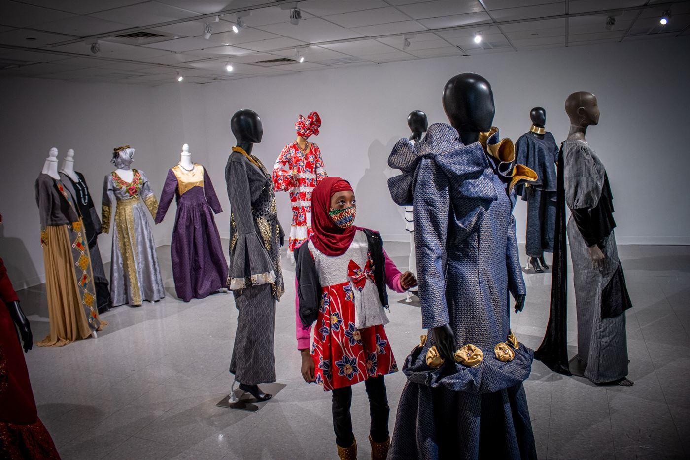 Nazeeha, Safiatou Akondo's daughter, admires her work. John LaRosa | The Montclarion