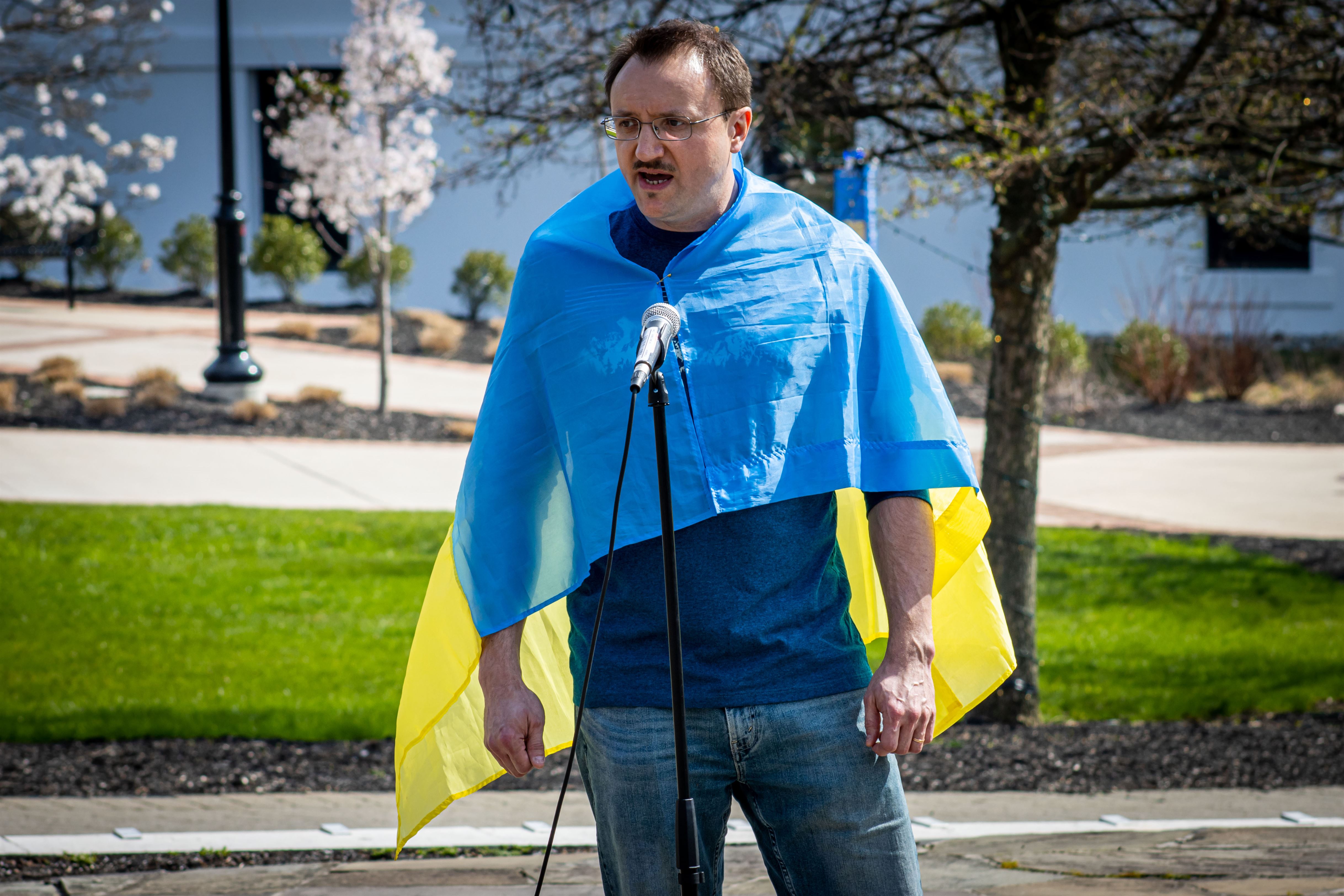 Viktor Turchyn, manager of computing lab services and technical support services, wears a Ukrainian flag while speaks about the innocent lives lost in the war. John LaRosa | The Montclarion