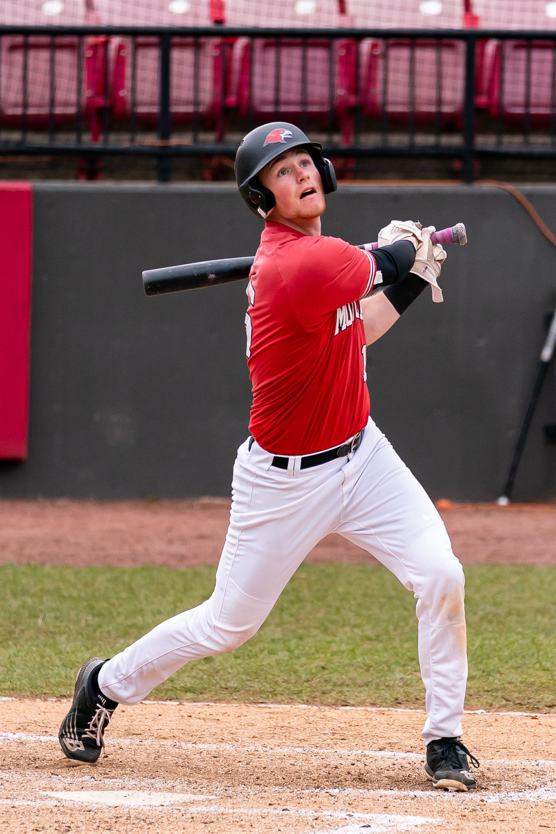 A Montclair State baseball player looks at the ball after swinging. Chris Krusberg | The Montclarion