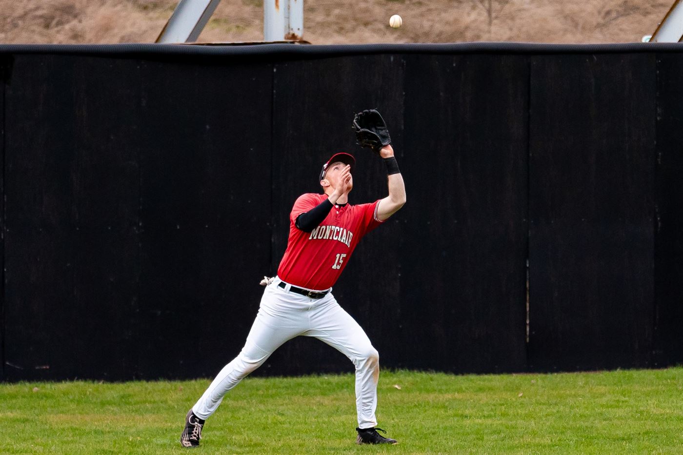 Senior outfielder Andrew Ollwerther tries to secure a fly ball. Chris Krusberg | The Montclarion