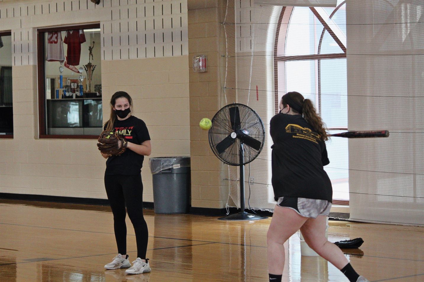 Hailey Farrell (left) watches teammate Tina Ilkow (right) bat for their teammates to warm up their pitches. Avery Nixon | The Montclarion