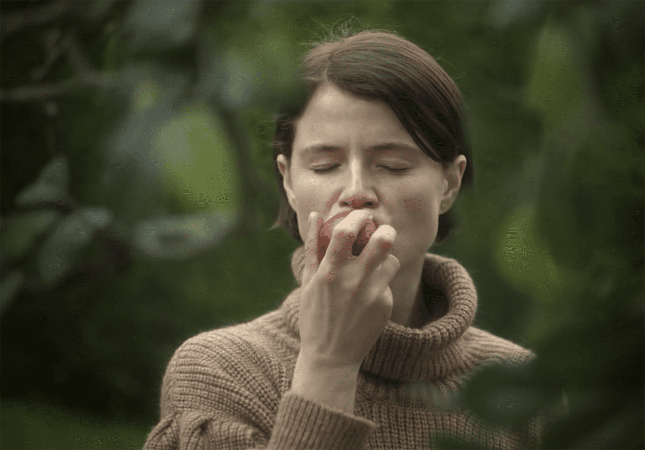 Harper (Jessie Buckley) takes a bite of the “forbidden fruit." Photo courtesy of A24