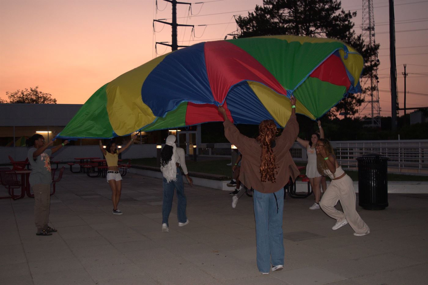 Students having fun with a gymnastic parachute outside the Student Center. Photo courtesy of Arely Reyes.