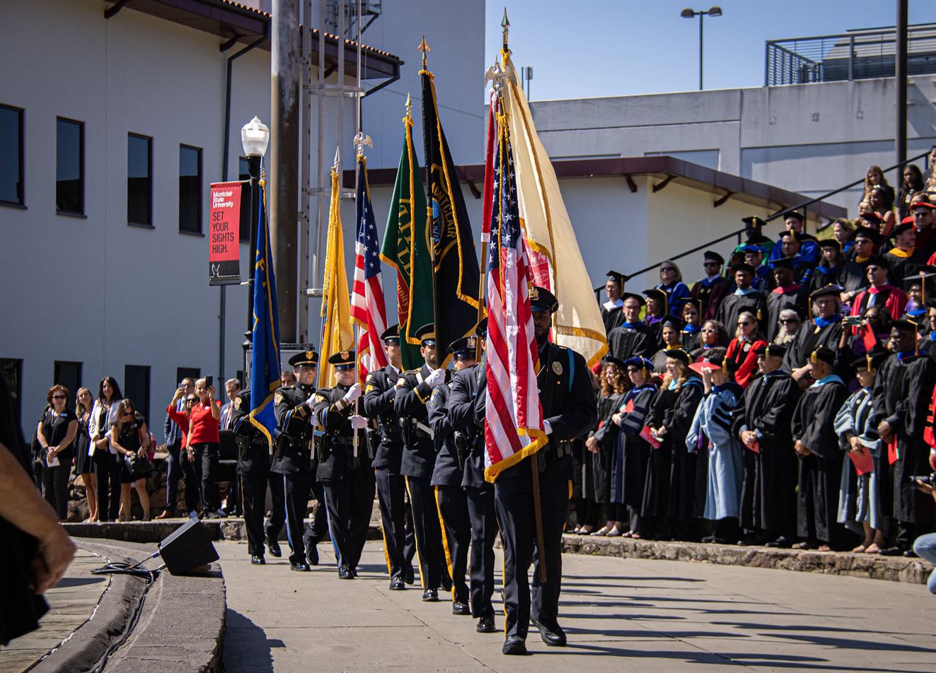 The color guards walk at the Amphitheater. Michelle Coneo | The Montclarion
