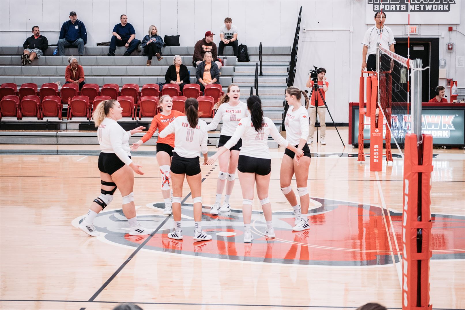 The Red Hawks celebrate after winning a point, something they did 75 times in this match. Dan Dreisbach | The Montclarion