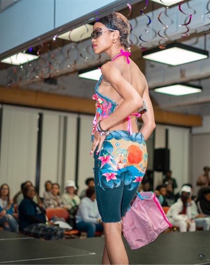 Sessoms walks down the runway in a fashion show. Photo courtesy of Anacia Sessoms