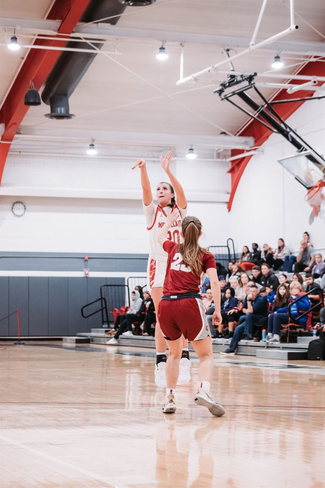 Megan Duffy shoots a three pointer right in front of a defender. Dan Dreisbach | The Montclarion