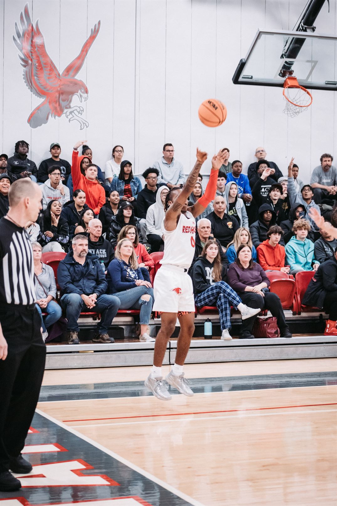 Kyree Henry goes up for a three-pointer with the Panzer crowd behind him rooting him on. Dan Dreisbach | The Montclarion