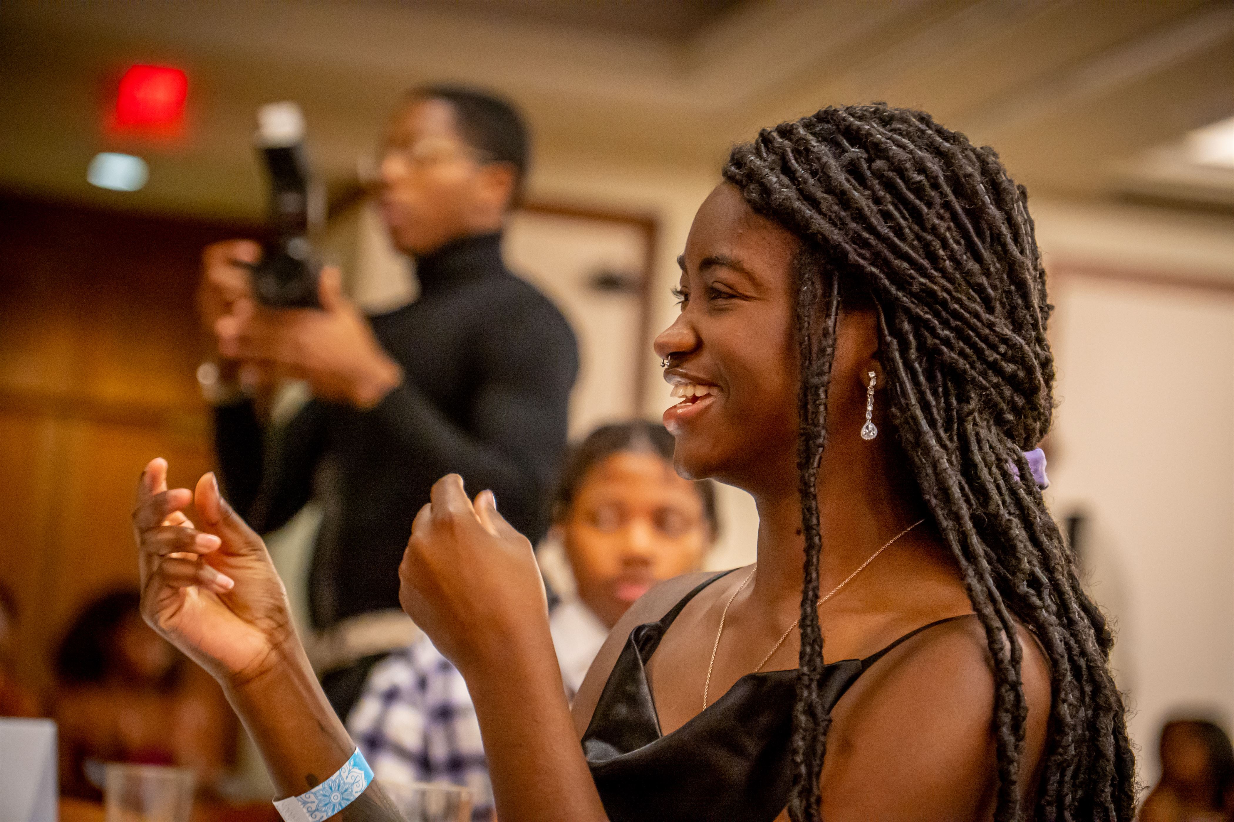 An unidentified woman applauds at the Harvest Ball. 
Lynise Olivacce | The Montclarion
