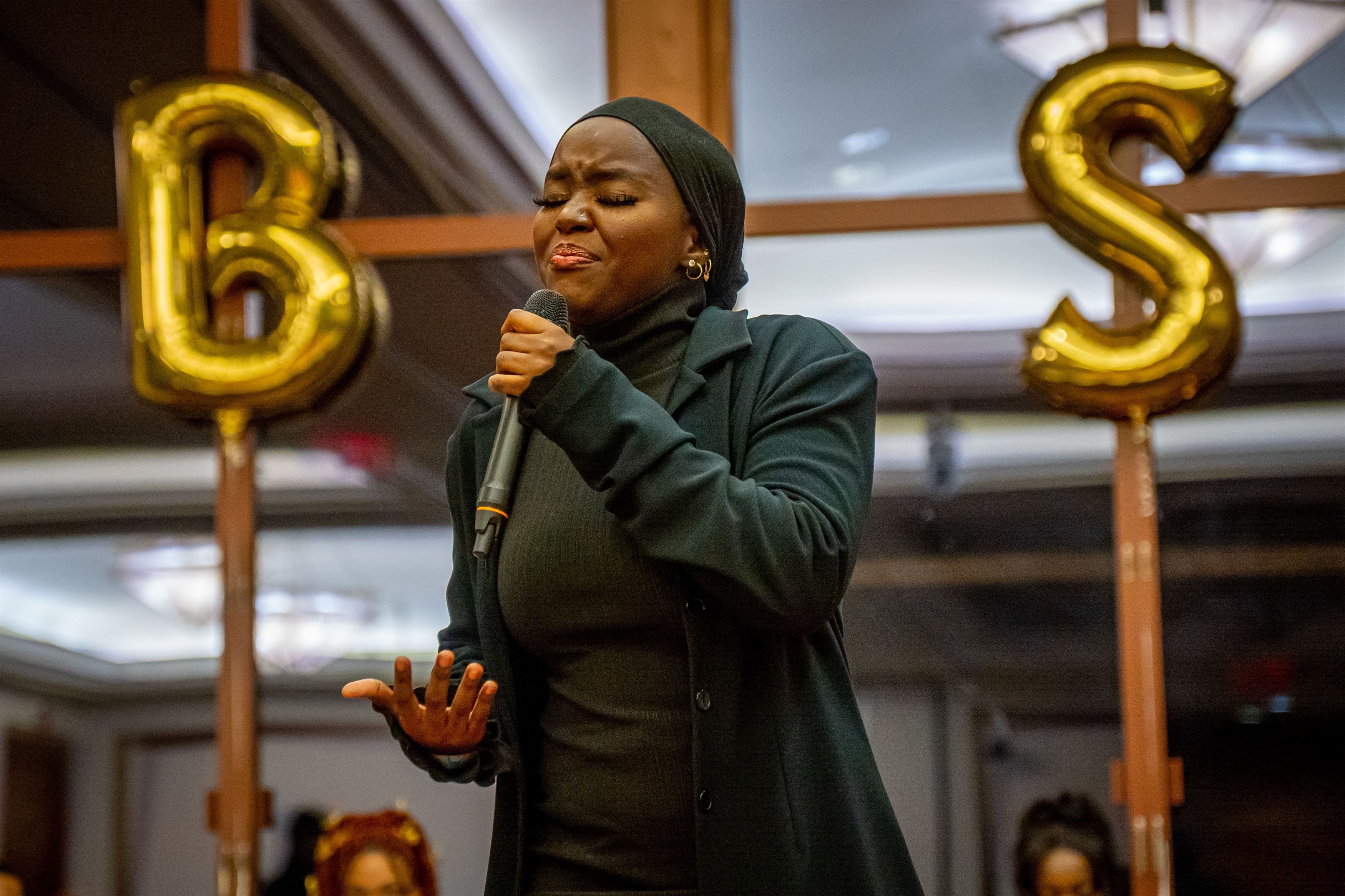 Fatoumata Amar recites her poem, 'Love Letter,' during the Harvest Ball. 
Lynise Olivacce | The Montclarion