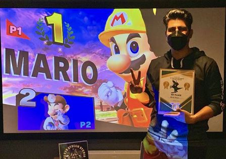 Winner of Super Smash Bros tournament Kevin Ortiz posing for a photograph, photo courtesy of owner Timmy Kellenyi.