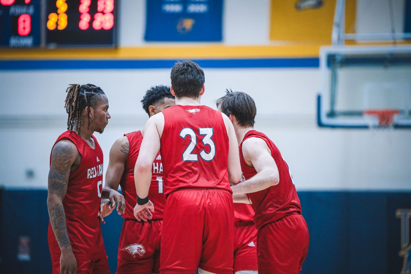 Henry, Pryce, Flanagan and Breeman huddle up on the court during the game. Markell Robinson | The Montclarion