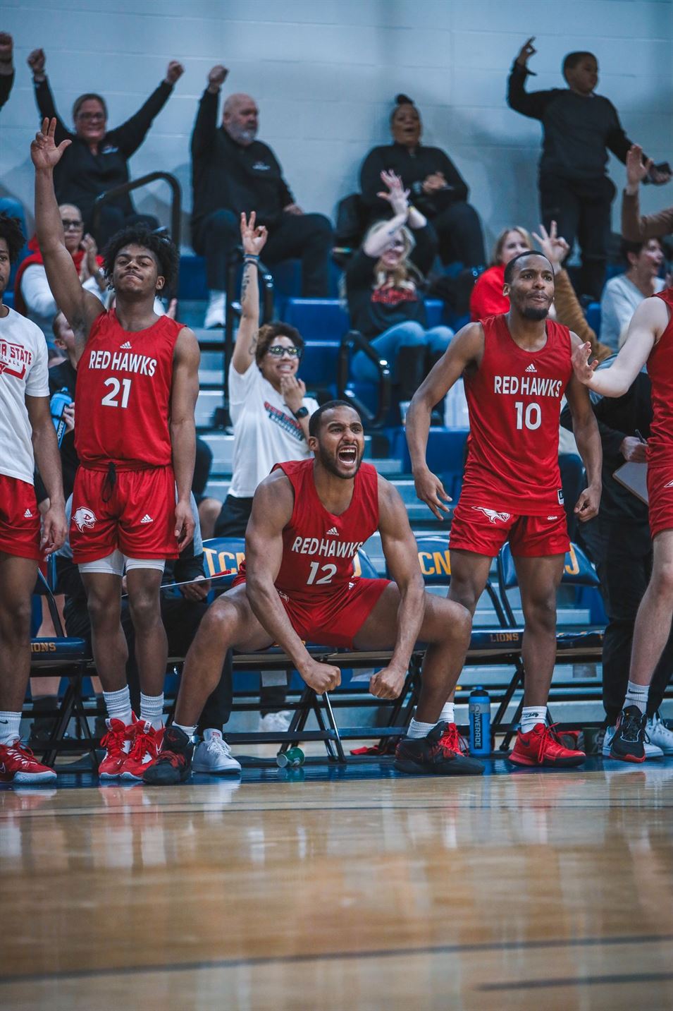Francisco Paulino celebrates on the bench after a shot is made for the Red Hawks. Markell Robinson | The Montclarion