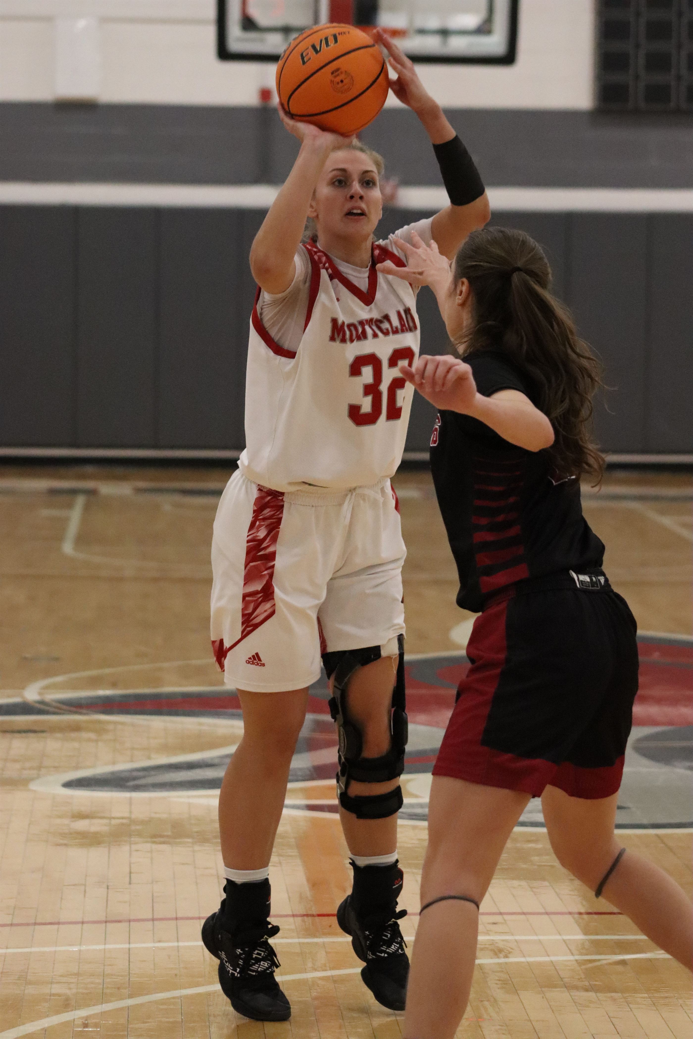 Teresa Wolak takes a shot with a defender's hand right towards her. Trevor Giesberg | The Montclarion