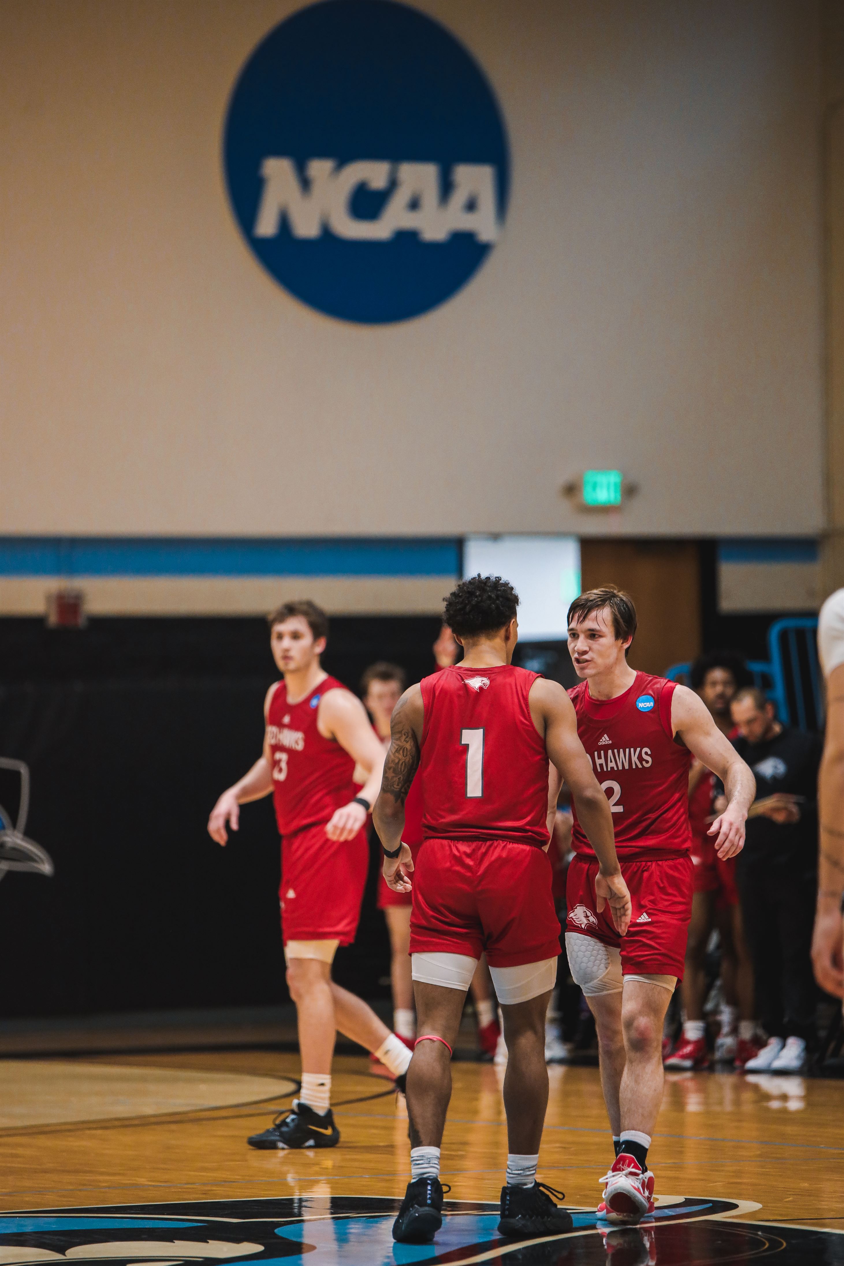 Junior guard Kieran Flanagan daps up senior guard Keyon Pryce after a play. Photo courtesy of Markell Robinson.