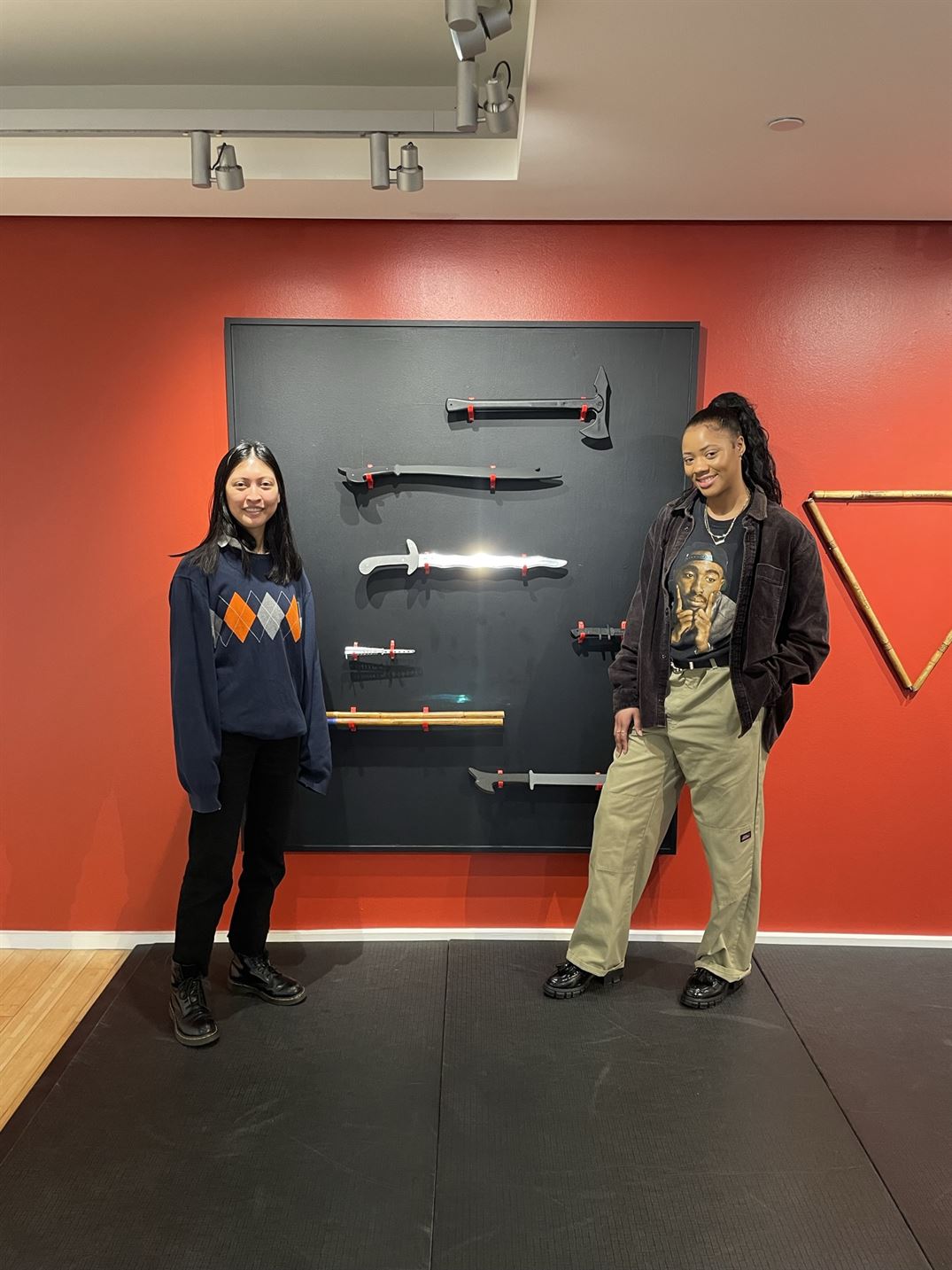 Alyssa Leslie Villasenor (left), the engagement outreach coordinator for the University Galleries, and Jajone Cuff, the student team leader of the gallery, stand by one of the exhibition's pieces.
Scott Ackerson | The Montclarion