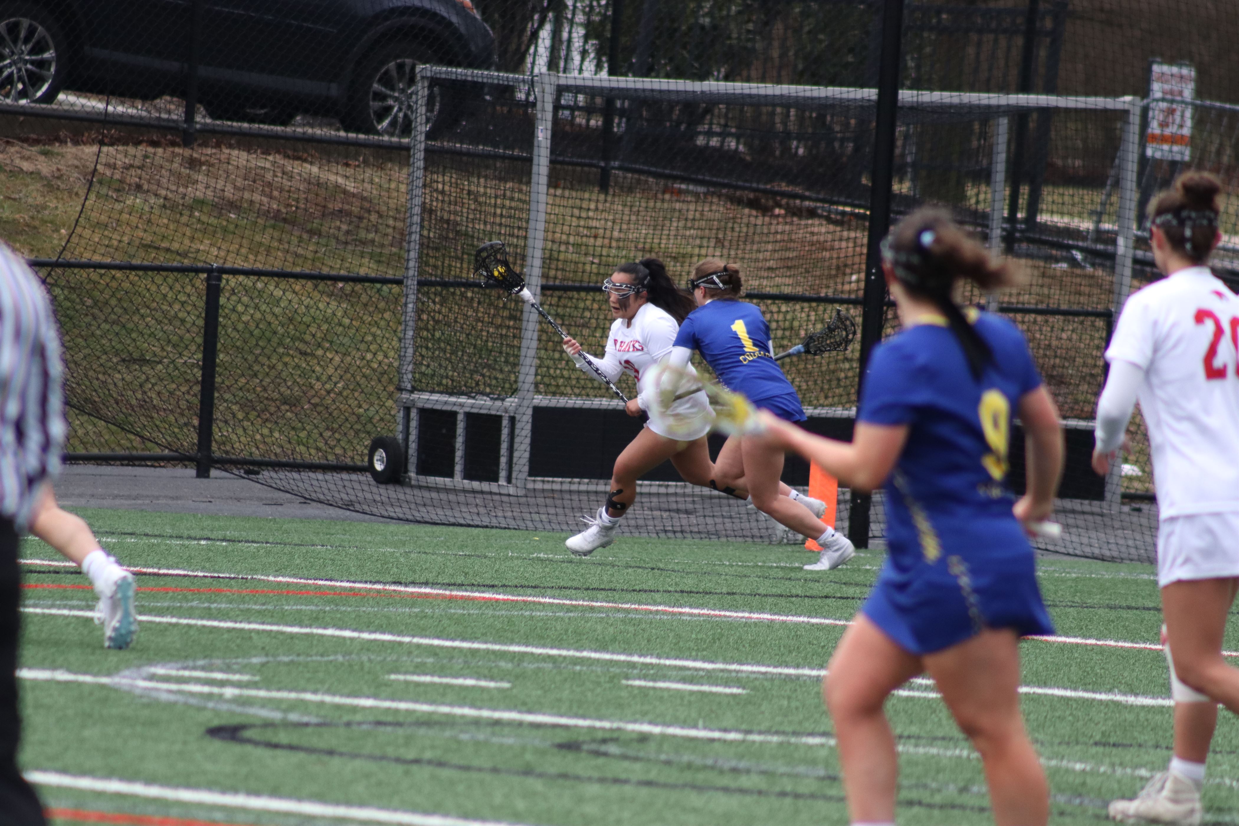 Freshman defender Danielle de Jesus runs with the ball with a Misericordia defender right behind her. Trevor Giesberg | The Montclarion