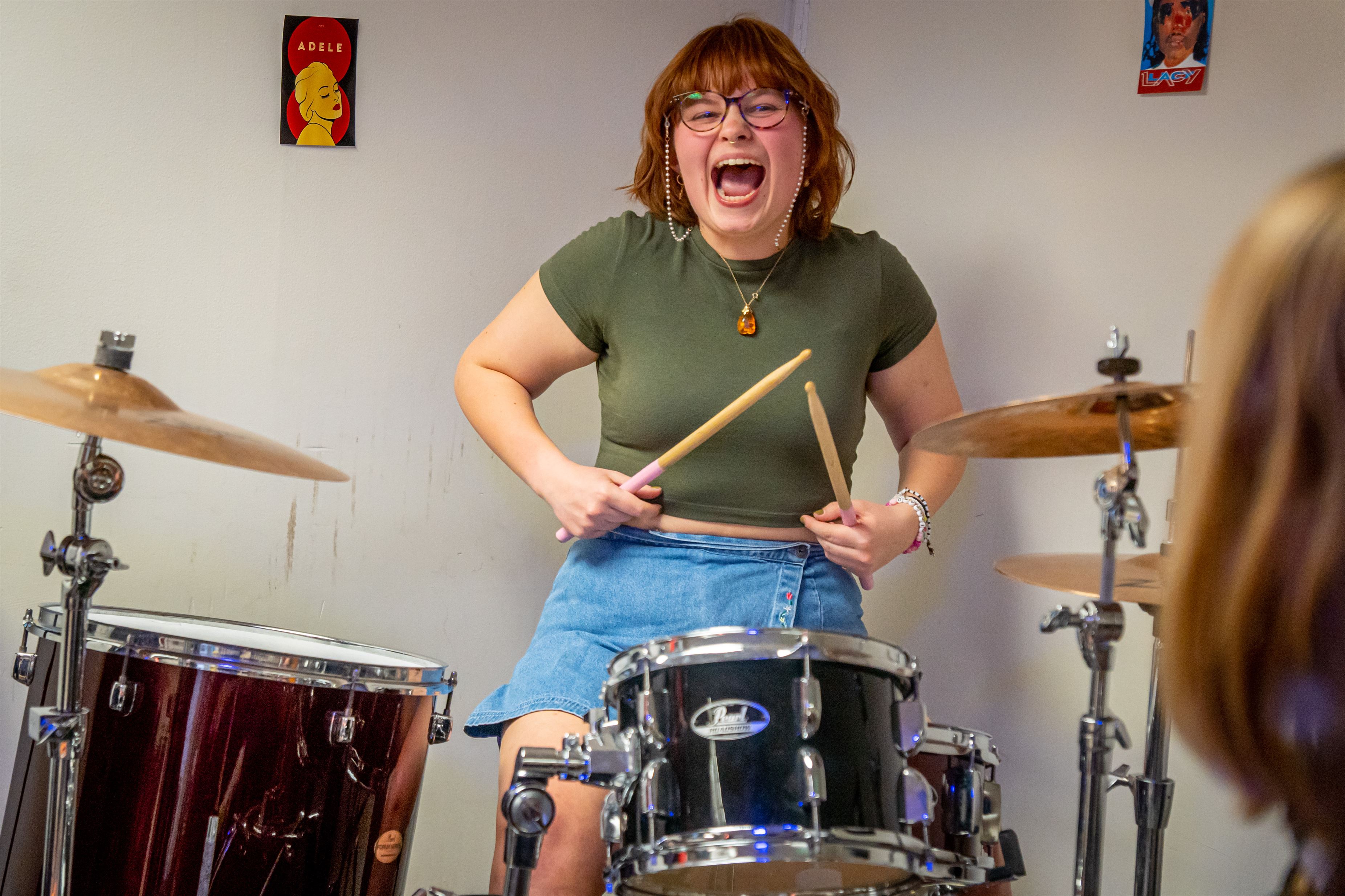 Allie Volltrauer, a sophomore theatre education major, plays the drums with excitement. 
Lynise Olivacce | The Montclarion