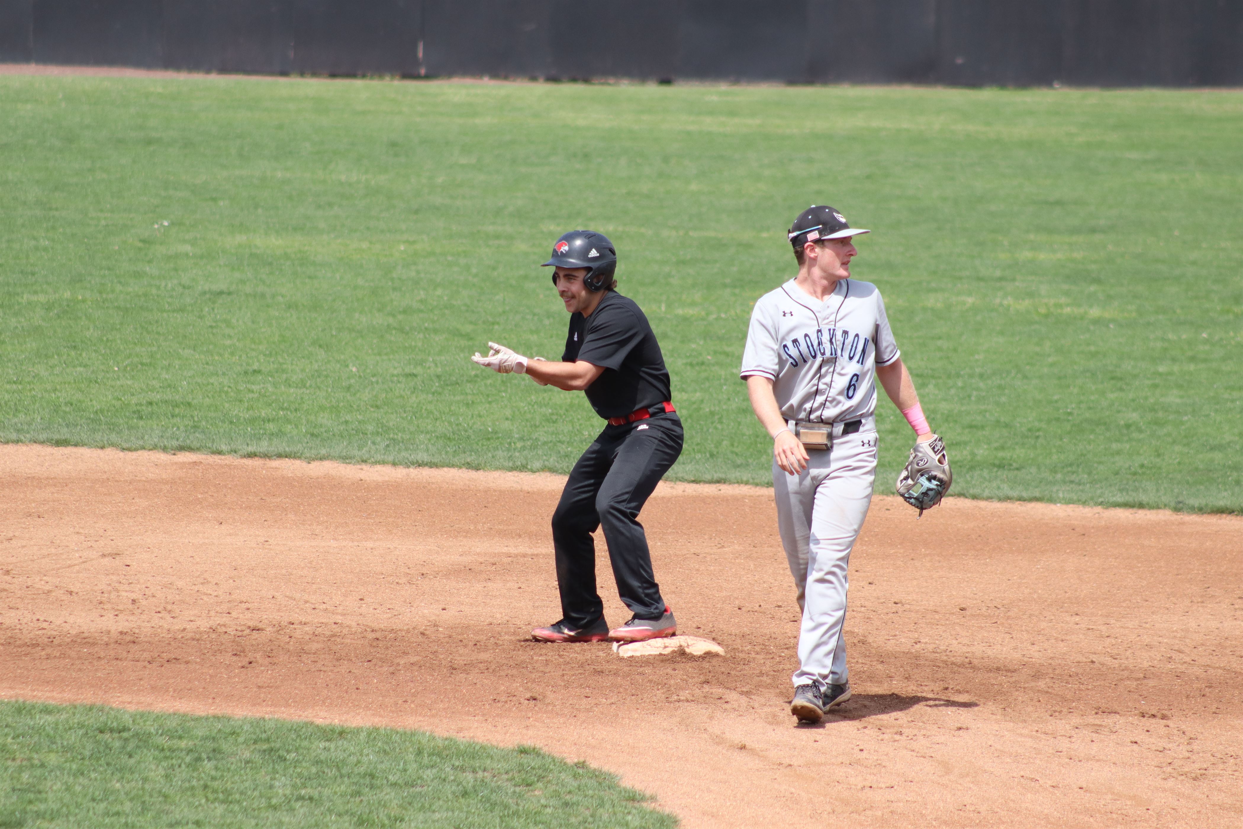 A celebration ensues on second base after a double is hit by the Red Hawks. Trevor Giesberg | The Montclarion
