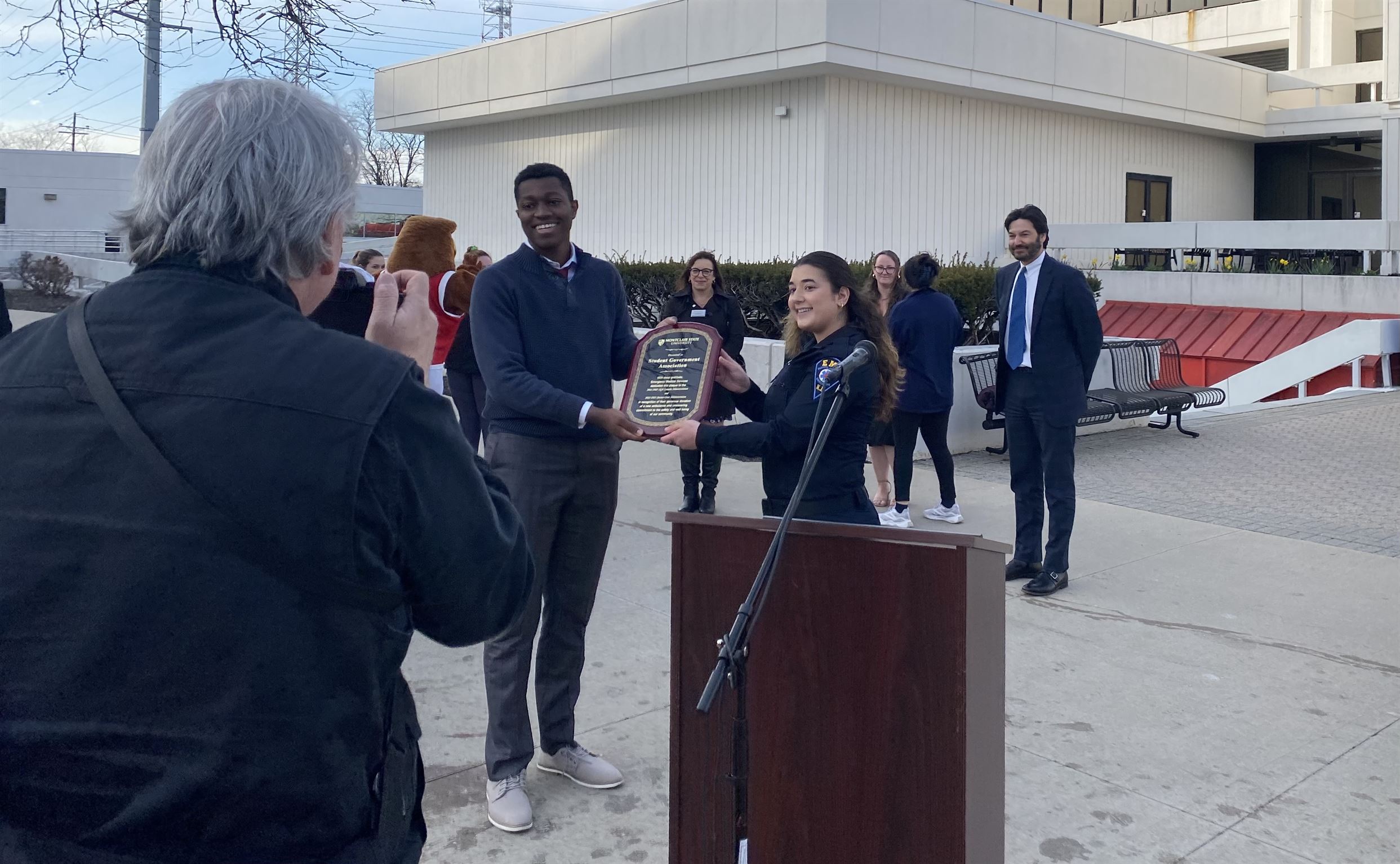 SGA President, Richard Steiner-Otoo, accepts a plaque thanking the SGA for their contribution.