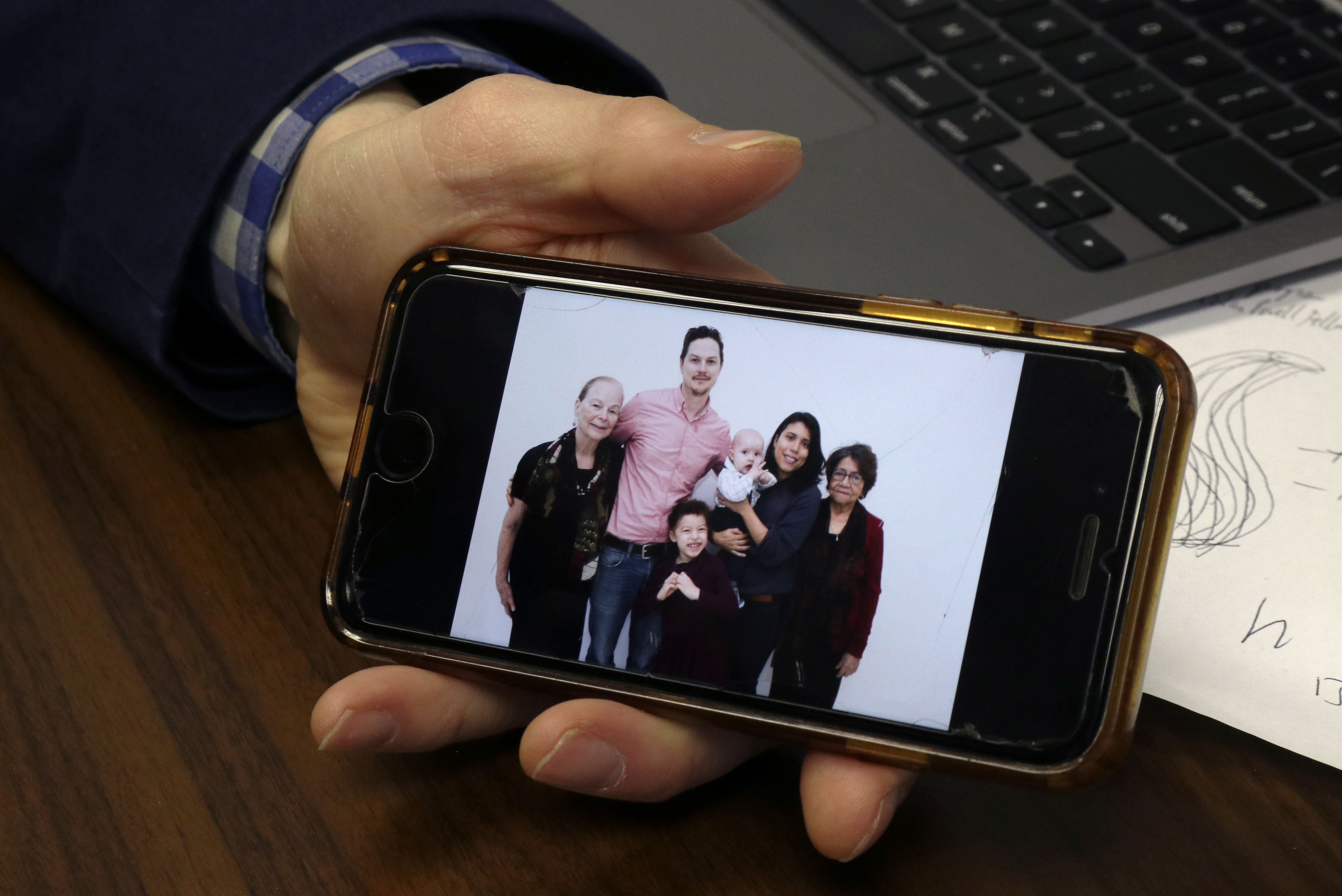 Associate professor of Latino sociology at Montclair State University, Stephen Ruszczyk, shows a picture of his family from his cell phone. Throughout the image, Ruszczyk introduced his children, who are half-Latino and half-white. President Joe Biden's proposal will help their children feel more comfortable in choosing the race they identify with in the future. Darian Mozo | The Montclarion