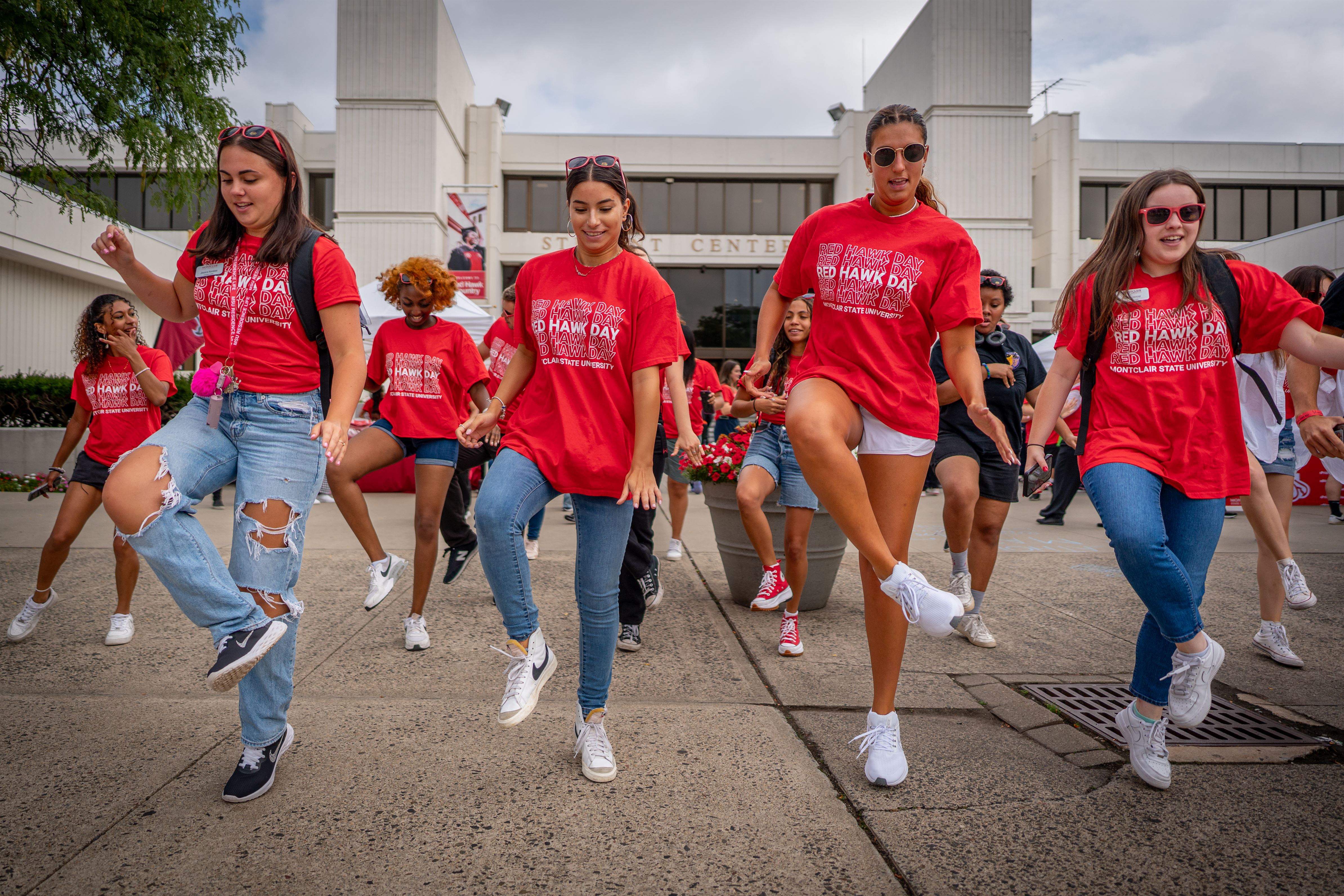 Students dance in front of the Student Center, at the beginning of Red Hawk Day, Tuesday, August 29th, 2023.