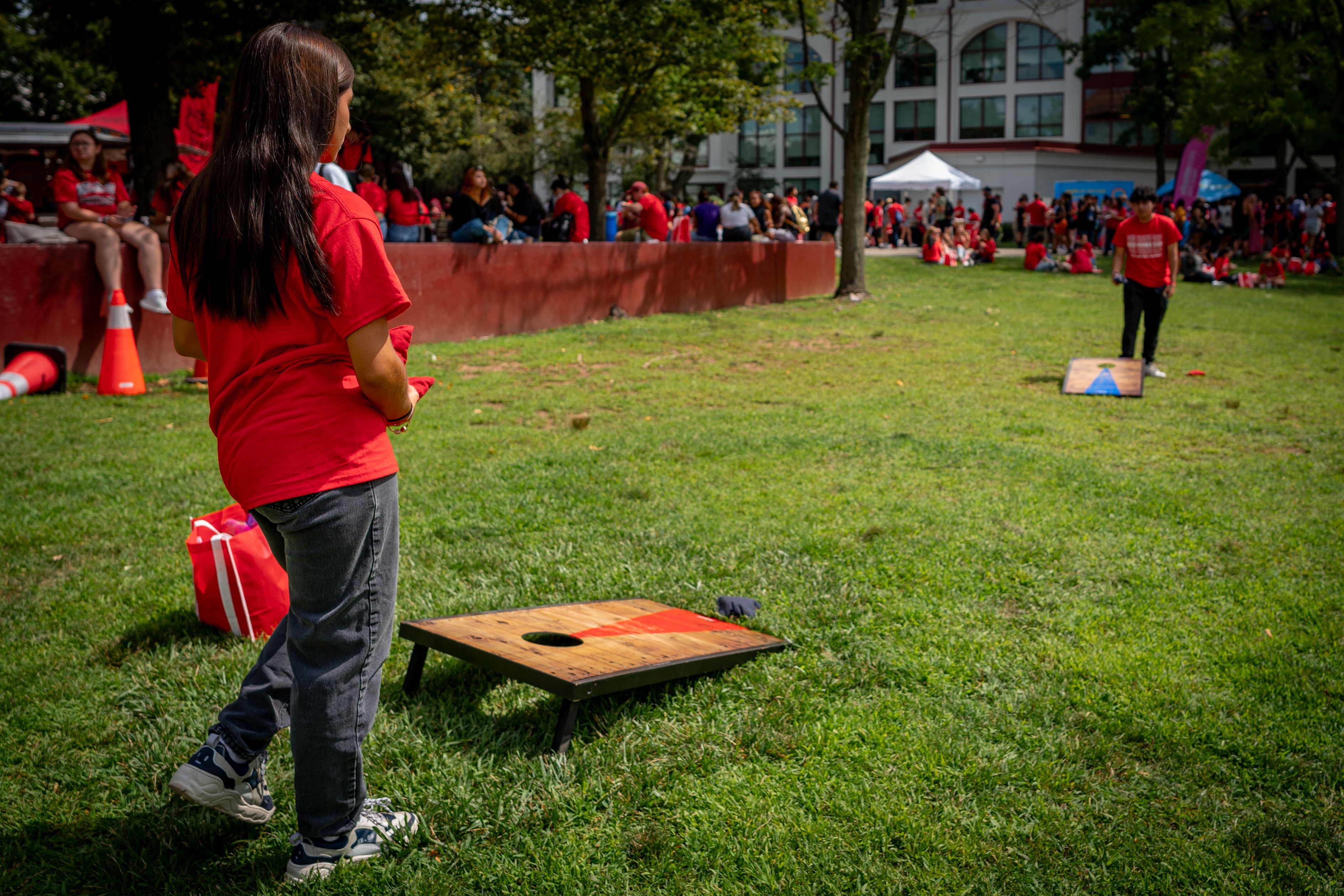 Ashley Sarango, a freshman exercise science major, plays Cornhole with Omar Bernal, a freshman film and TV major, at Red Hawk Day, Tuesday, August 29th, 2023.