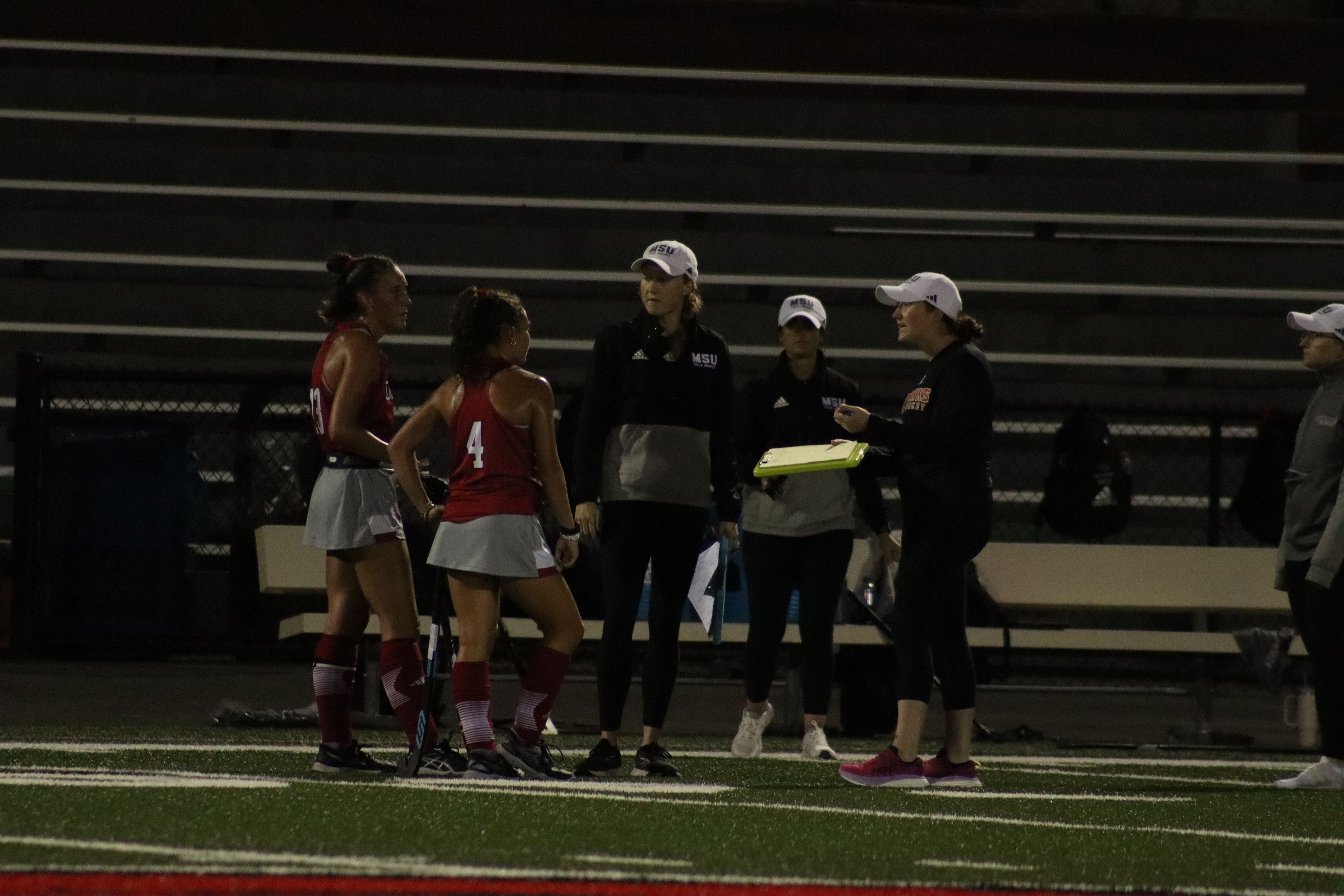 Tori Sutera and Kylie Compton talking things over with the Montclair State staff. Photo courtesy of Trevor Giesberg