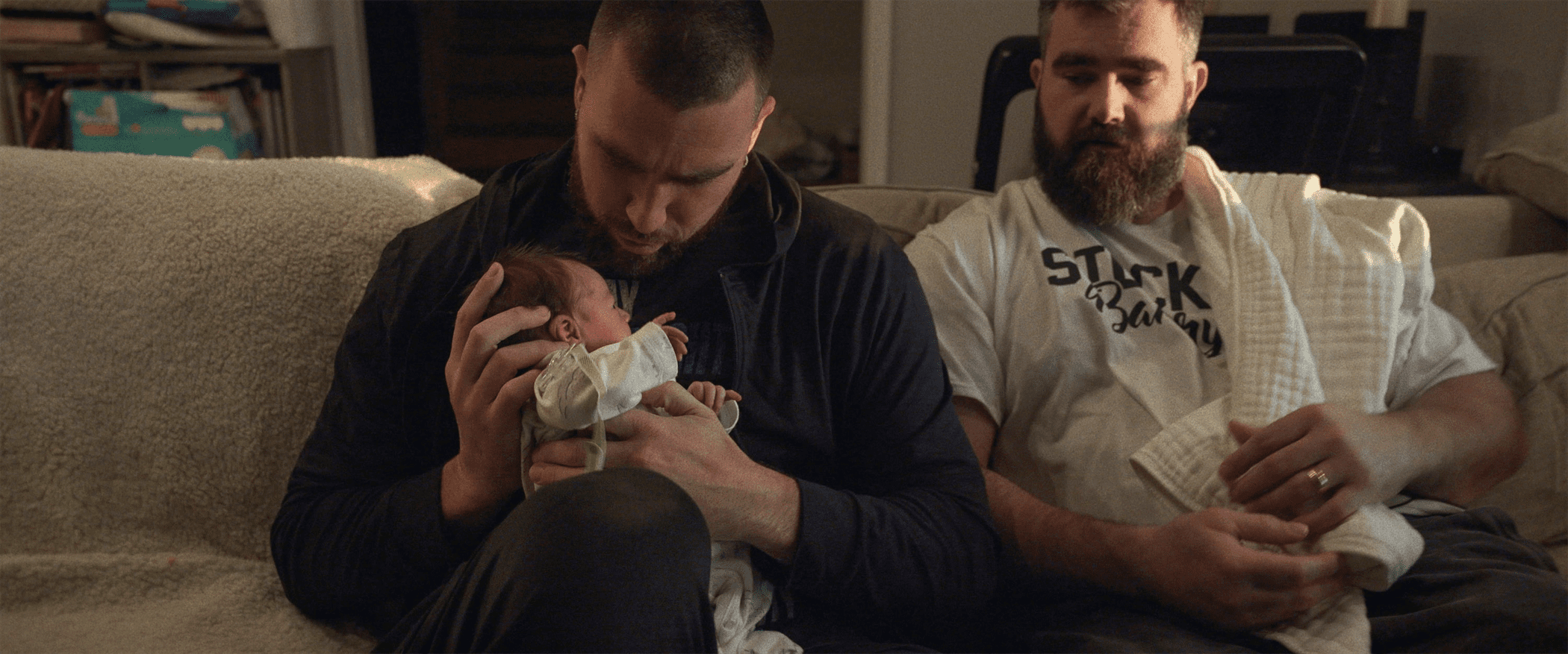 Travis Kelce (left) holding his niece for the first time as Jason Kelce (right) watches on. Photo courtesy of Vera Y Productions