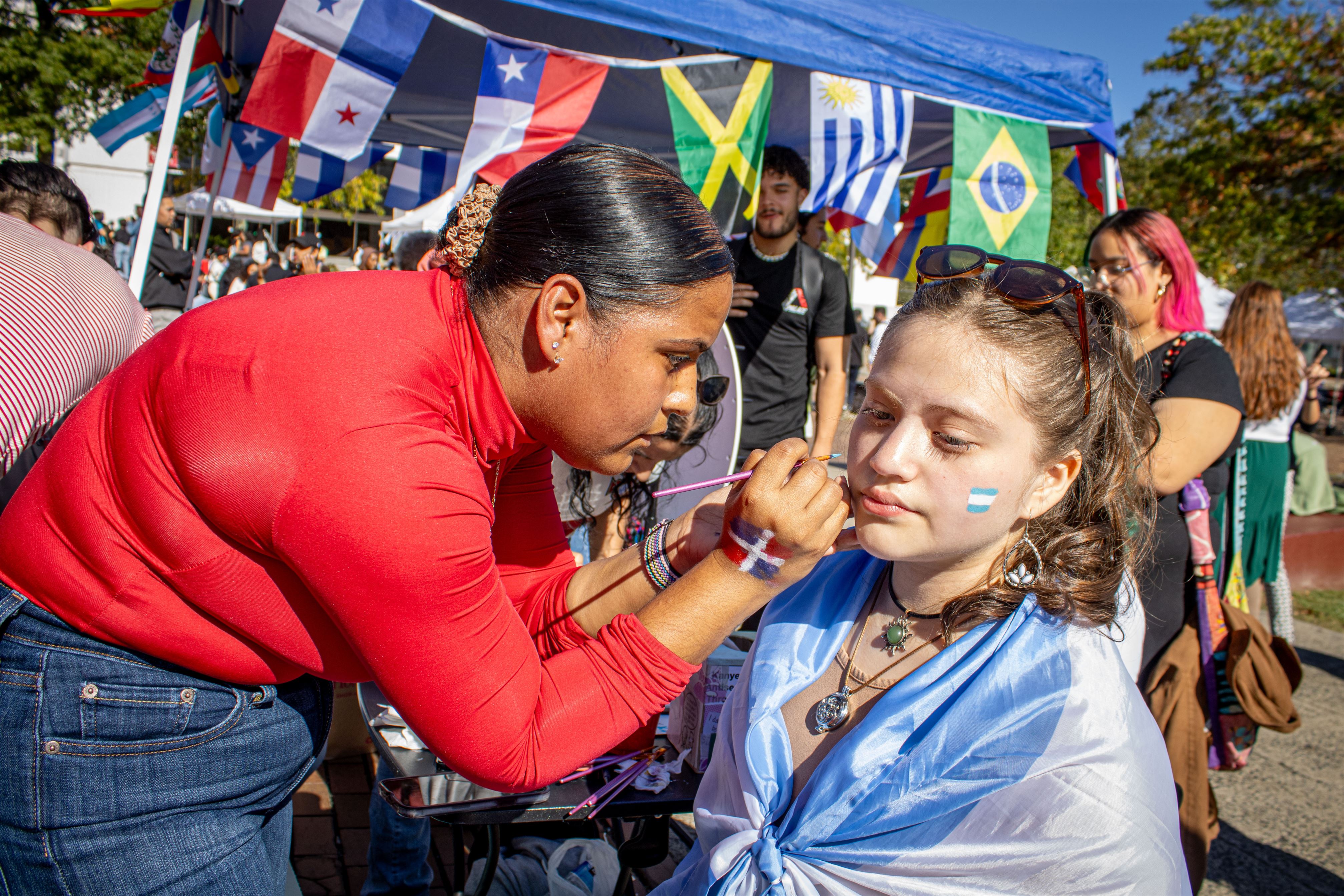 Grace Velazquez, a freshman social media and public relations major having the Argentinian flag painted on her face. Dani Mazariegos | The Montclarion