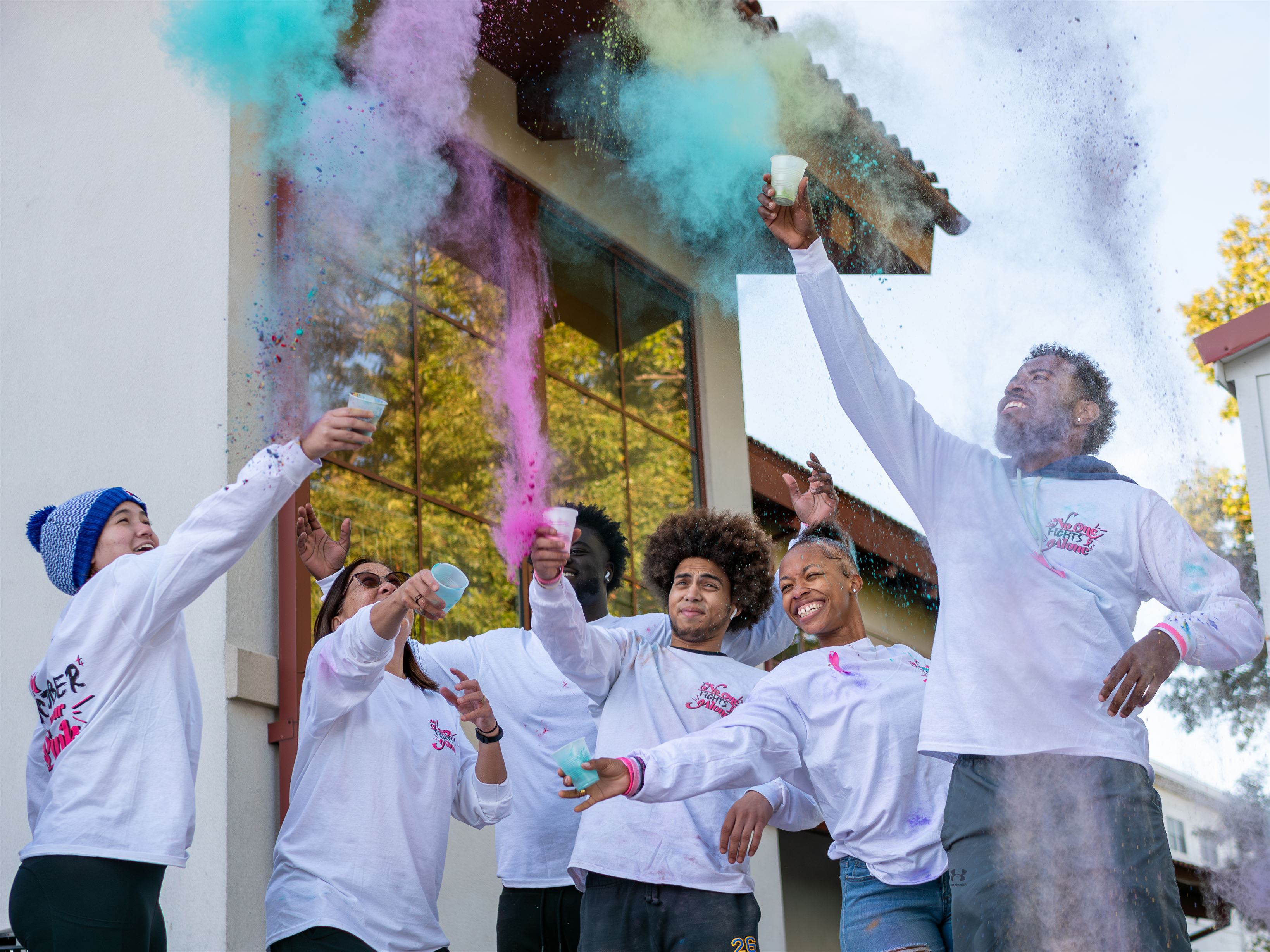 Campus Recreation Center staff throwing paint in the air at the Cancer Awareness Walk event. Photo courtesy of Maral Tutunjian | The Montclarion