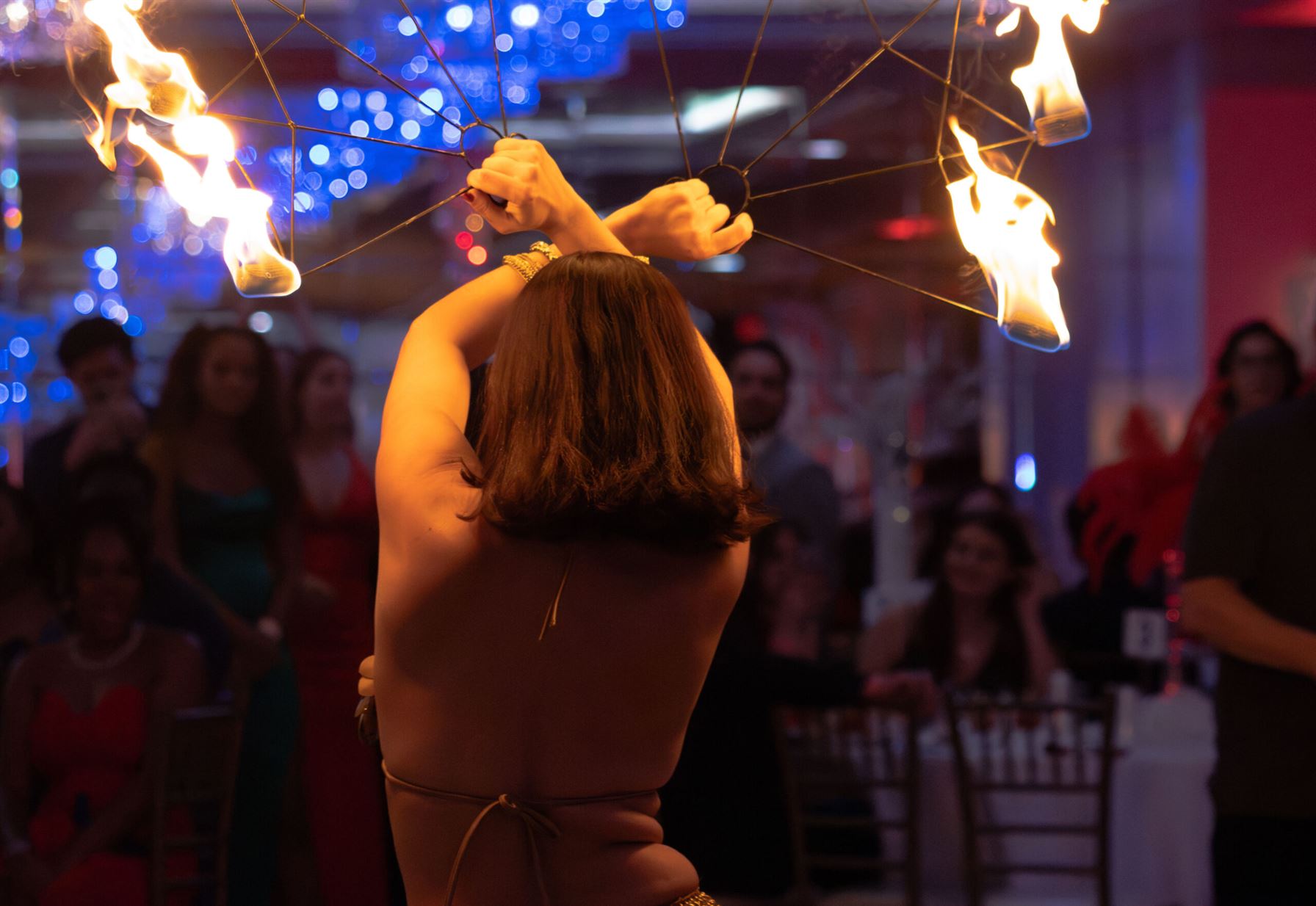 A professional fire dancer performs at the gala as students gather around. Photo by Victoria Howell