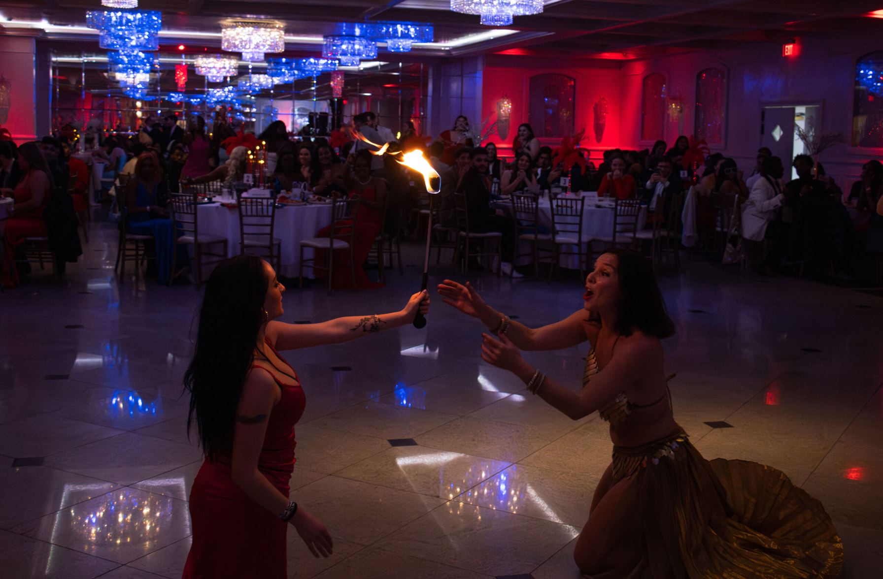 The fire dancer passes torch to an audience member. - Photo by Victoria Howell