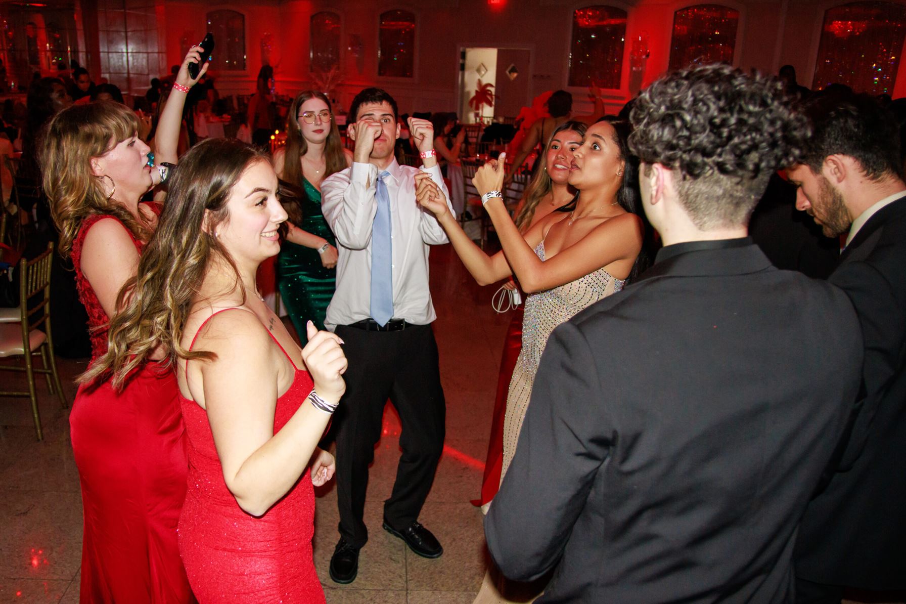 Students dance in a circle during SLAM's Winter Gala at The Royal Manor in Garfield, N.J. Sal DiMaggio | The Montclarion
