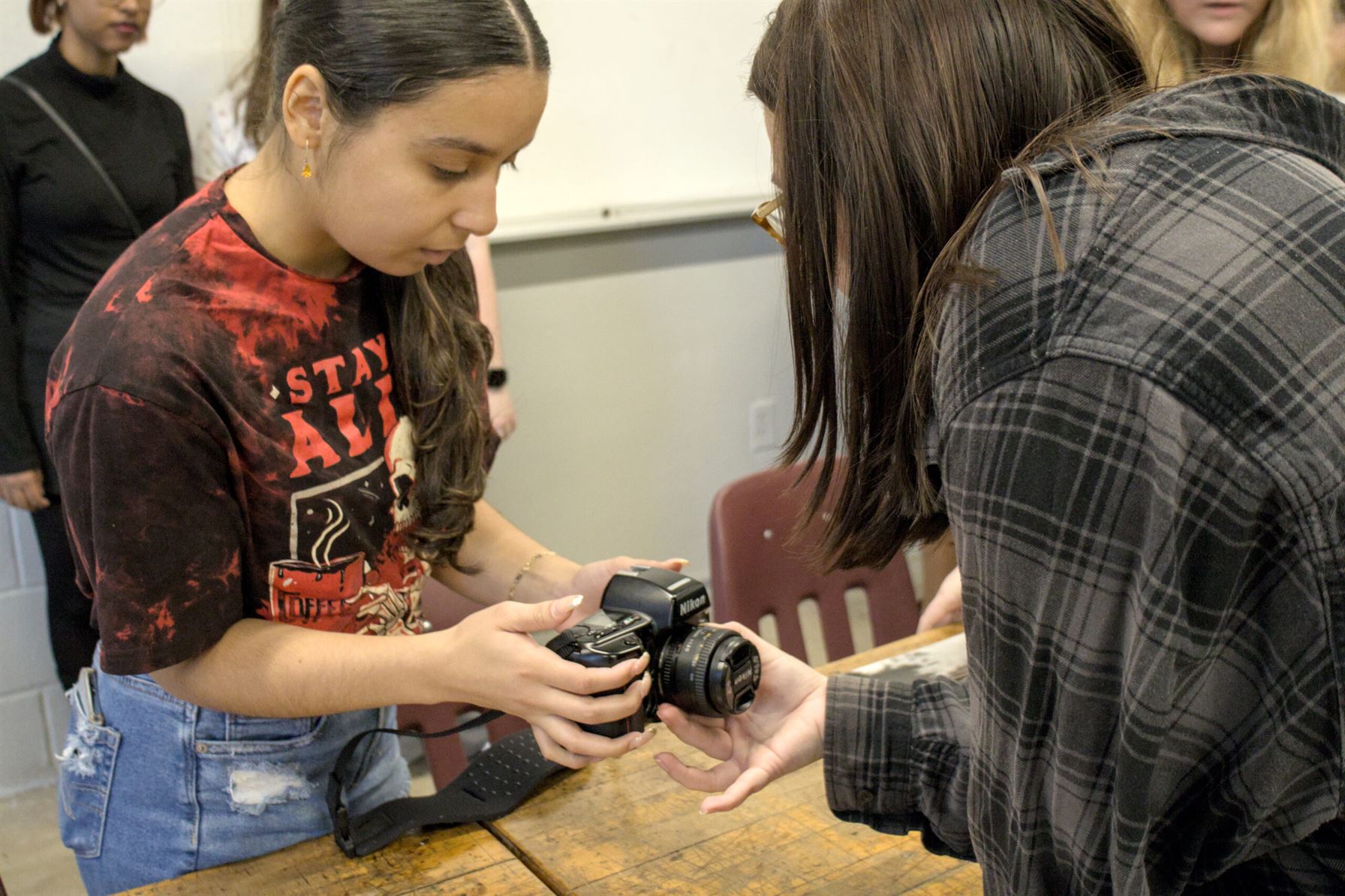 Two members of the photo club work together to solve a technical problem. Photo courtesy of Allen Macaraeg