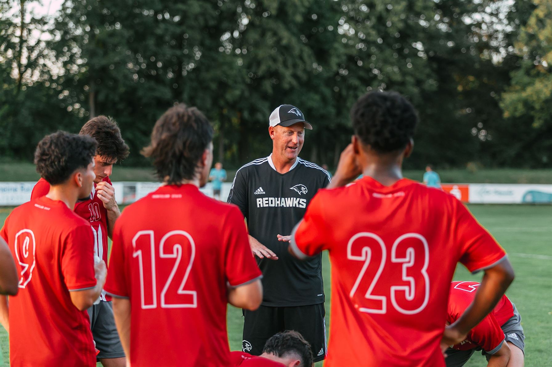 Head coach Todd Tumelty and the Red Hawks during the pre-season trip to Germany. Vinny Gollotto | The Montclarion