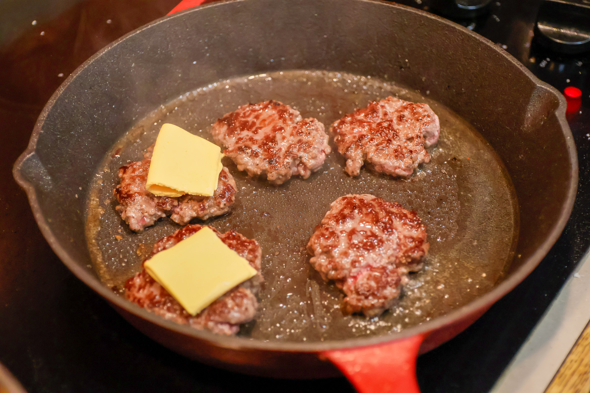 Once cooked through on one side, which should only take a minute or two considering the small size of the burgers, quickly flip over and adorn the patties with American cheese.
Sal DiMAggio | The Montclarion