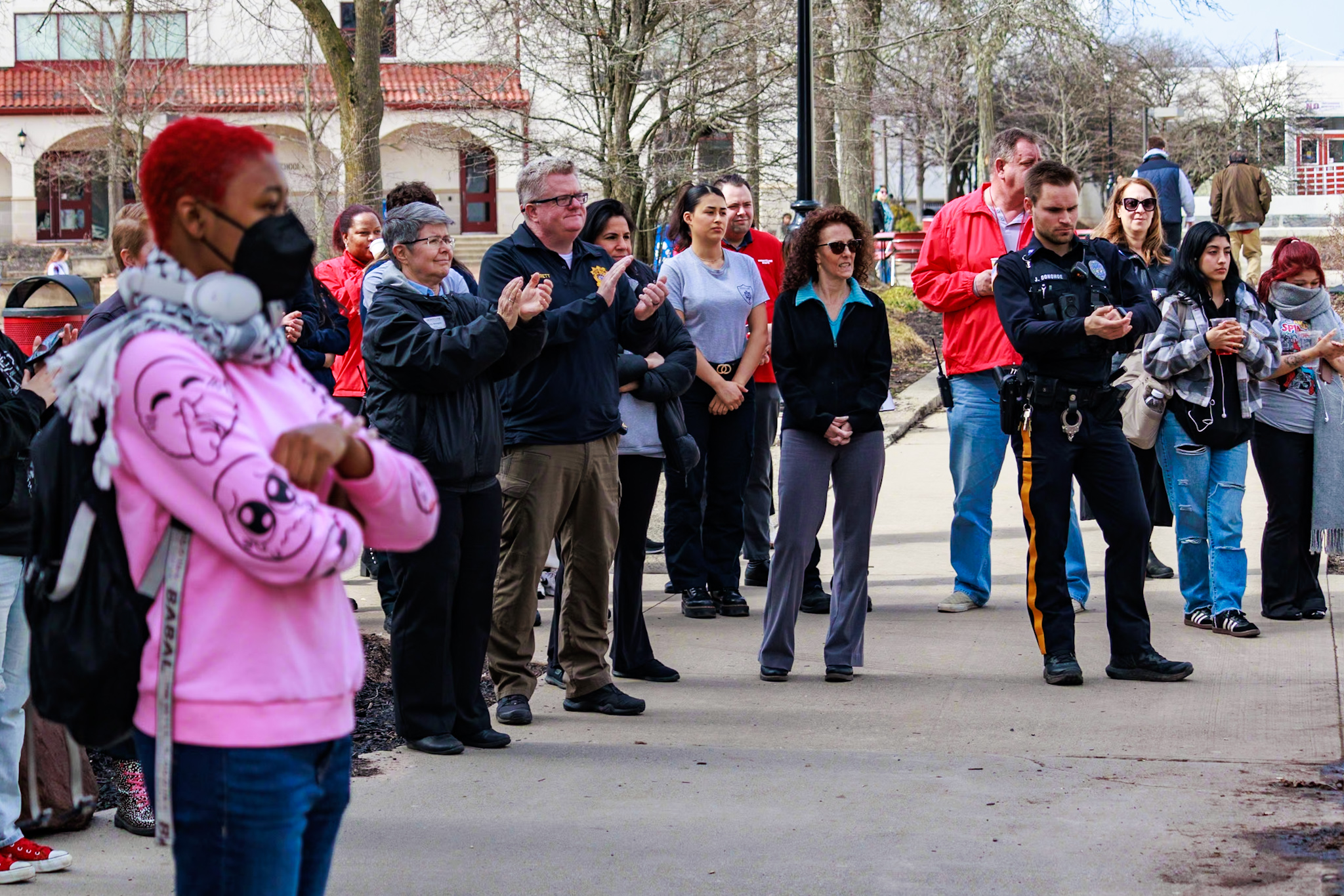 Members of the campus community watch the Women's History Month flag-raising event.
Sal DiMaggio | The Montclarion