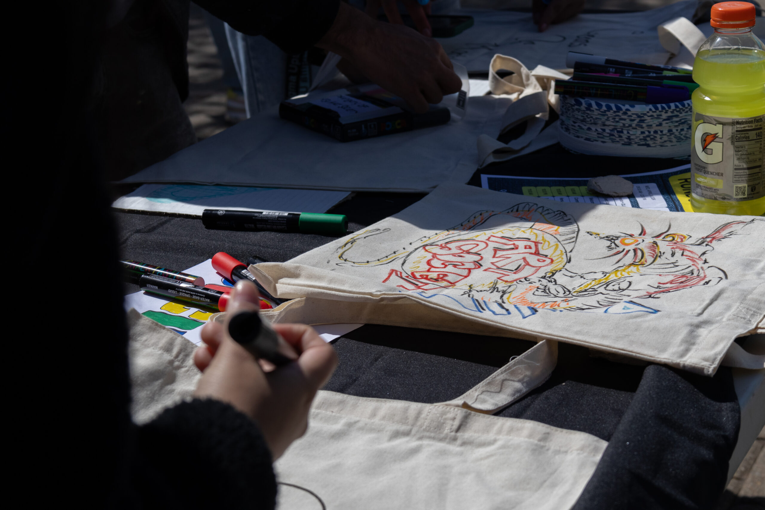 The table of Montclair State's Art Society, where students got to design their own tote bags. Allen Macaraeg | The Montclarion