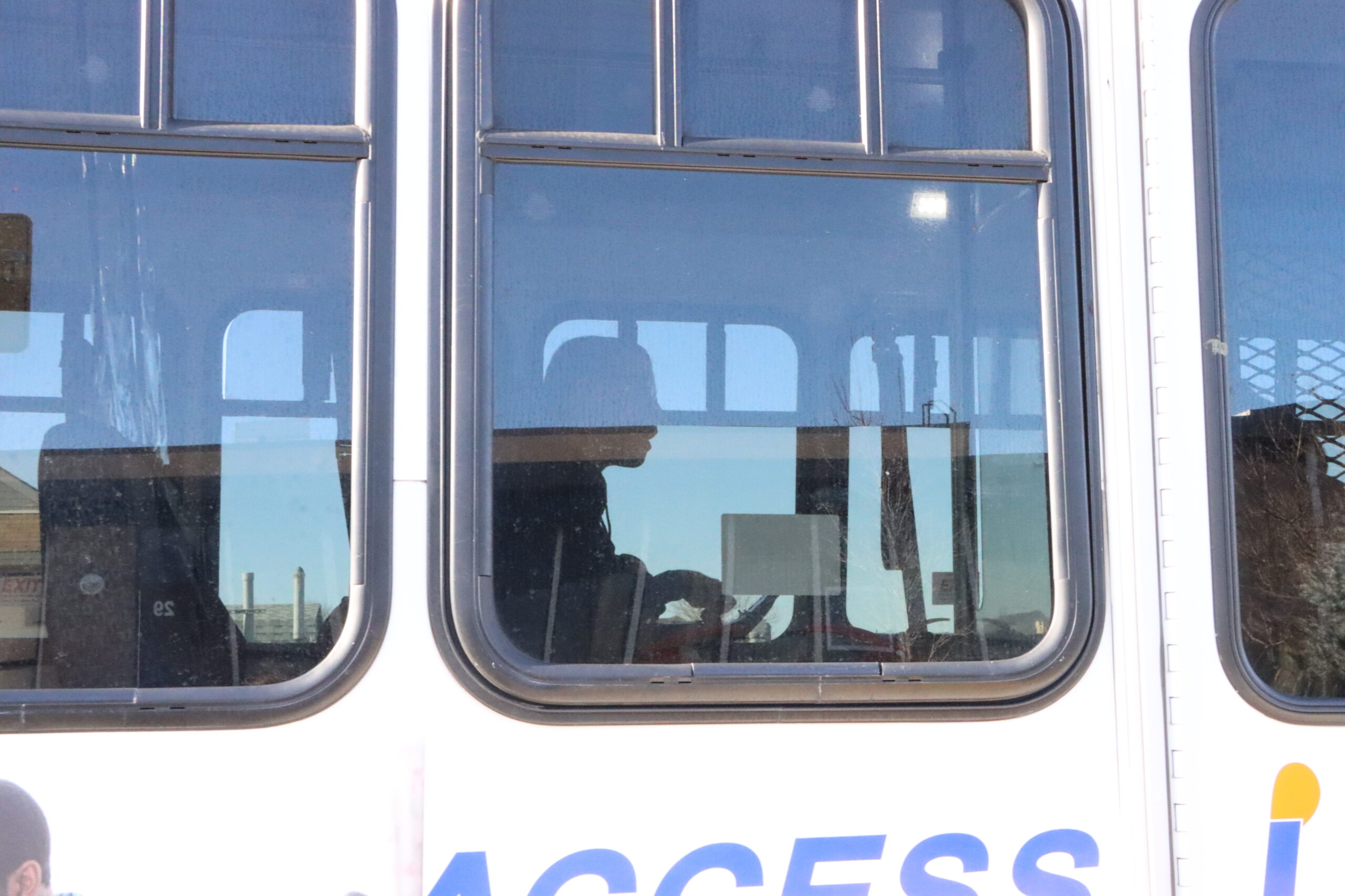 Jacob Hackett waits to be buckled in on the Access Link bus.