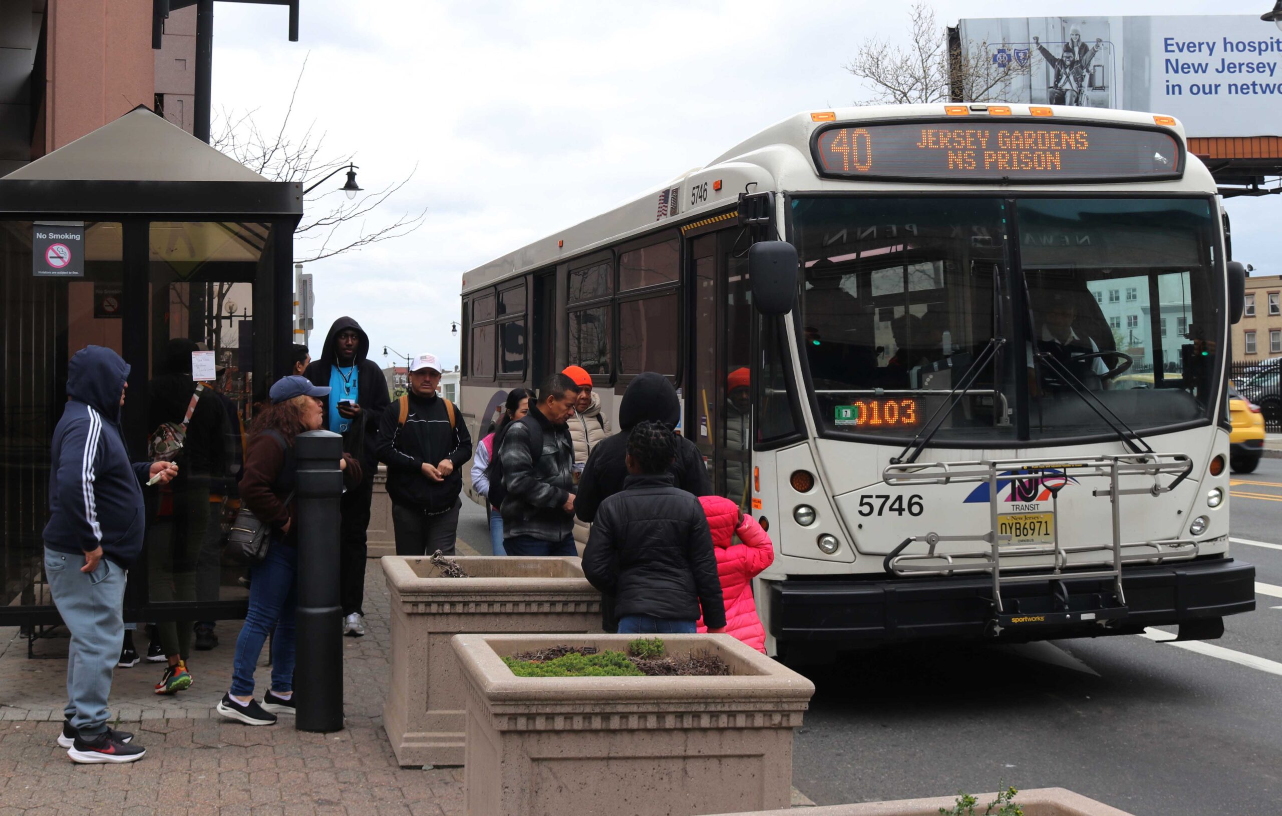 People standing by a Newark bus stop waiting to enter NJ Transit bus. Nadya Grisczenkow | The Montclarion