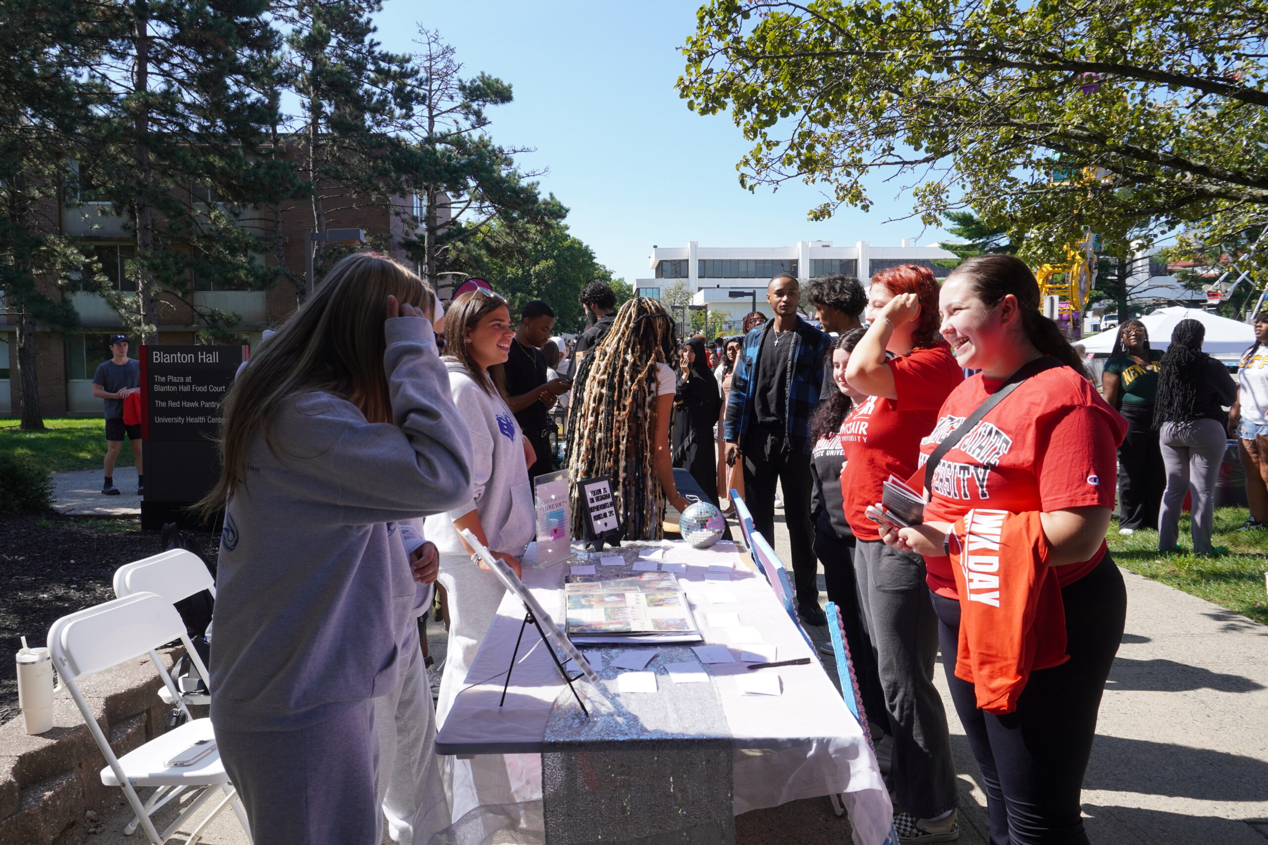 Students talk to members of a club at their table in the involvement fair. Jordan Reed | The Montclarion