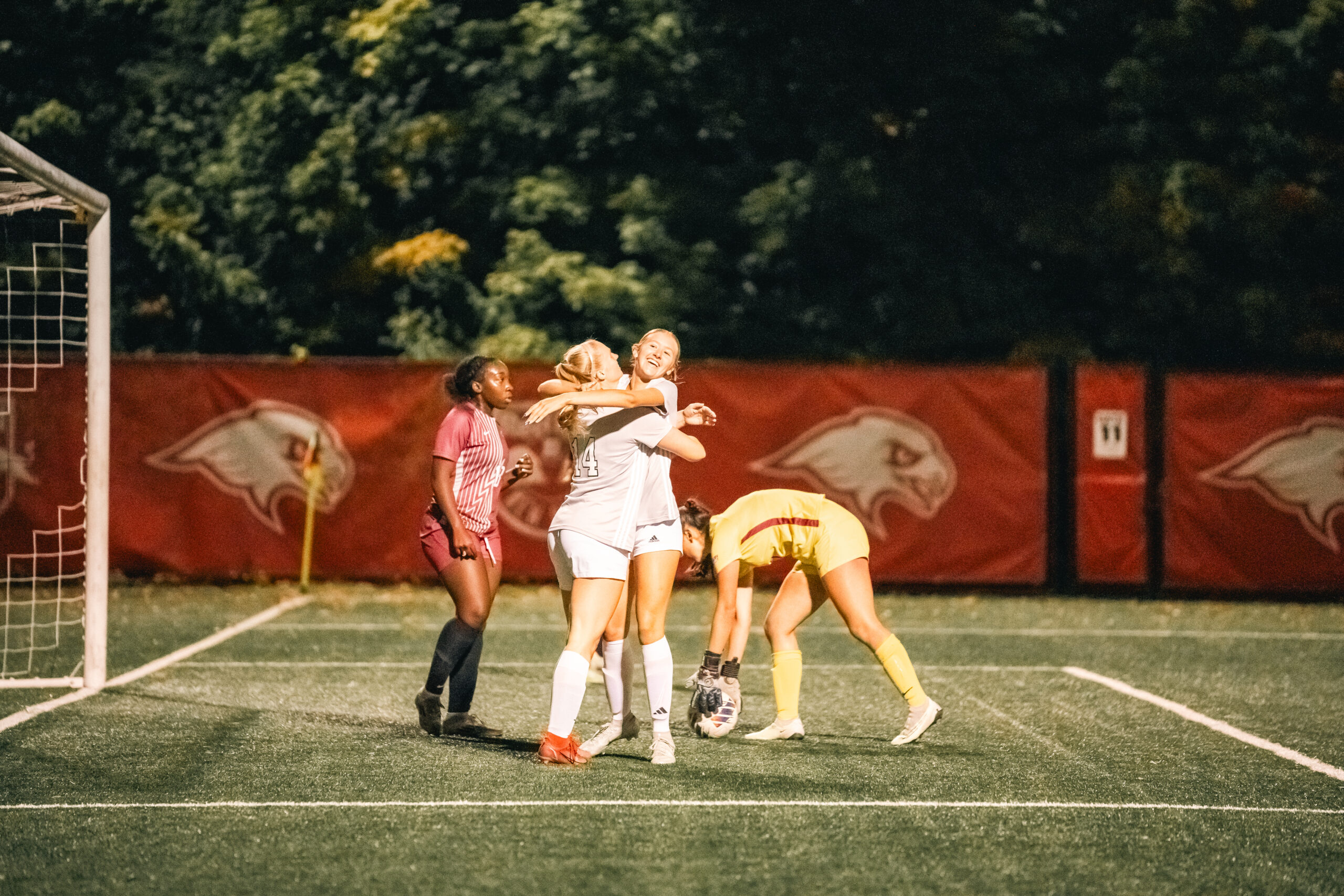 Danz celebrates a goal with her teammate.