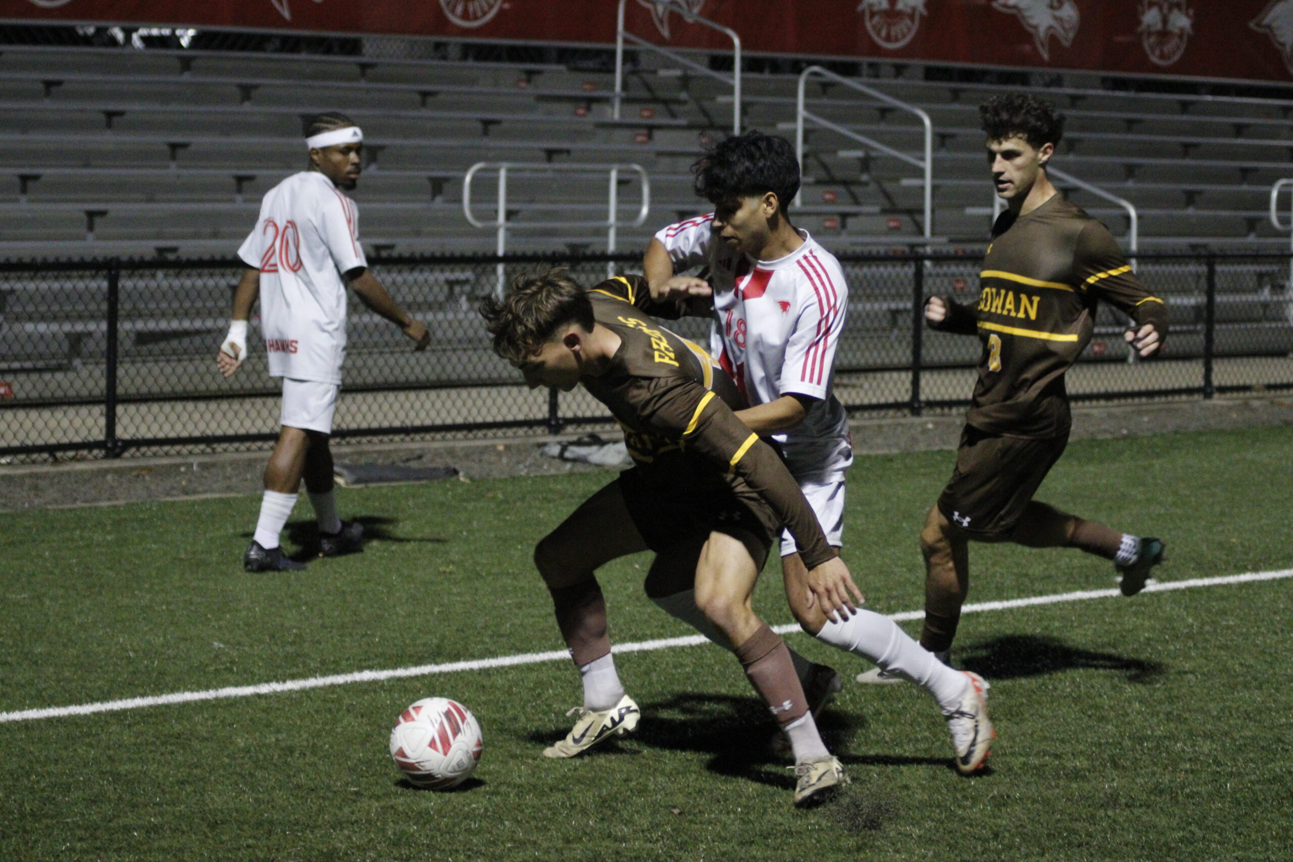 Freshman Forward Kevin Contreras fights with a Prof for possession.