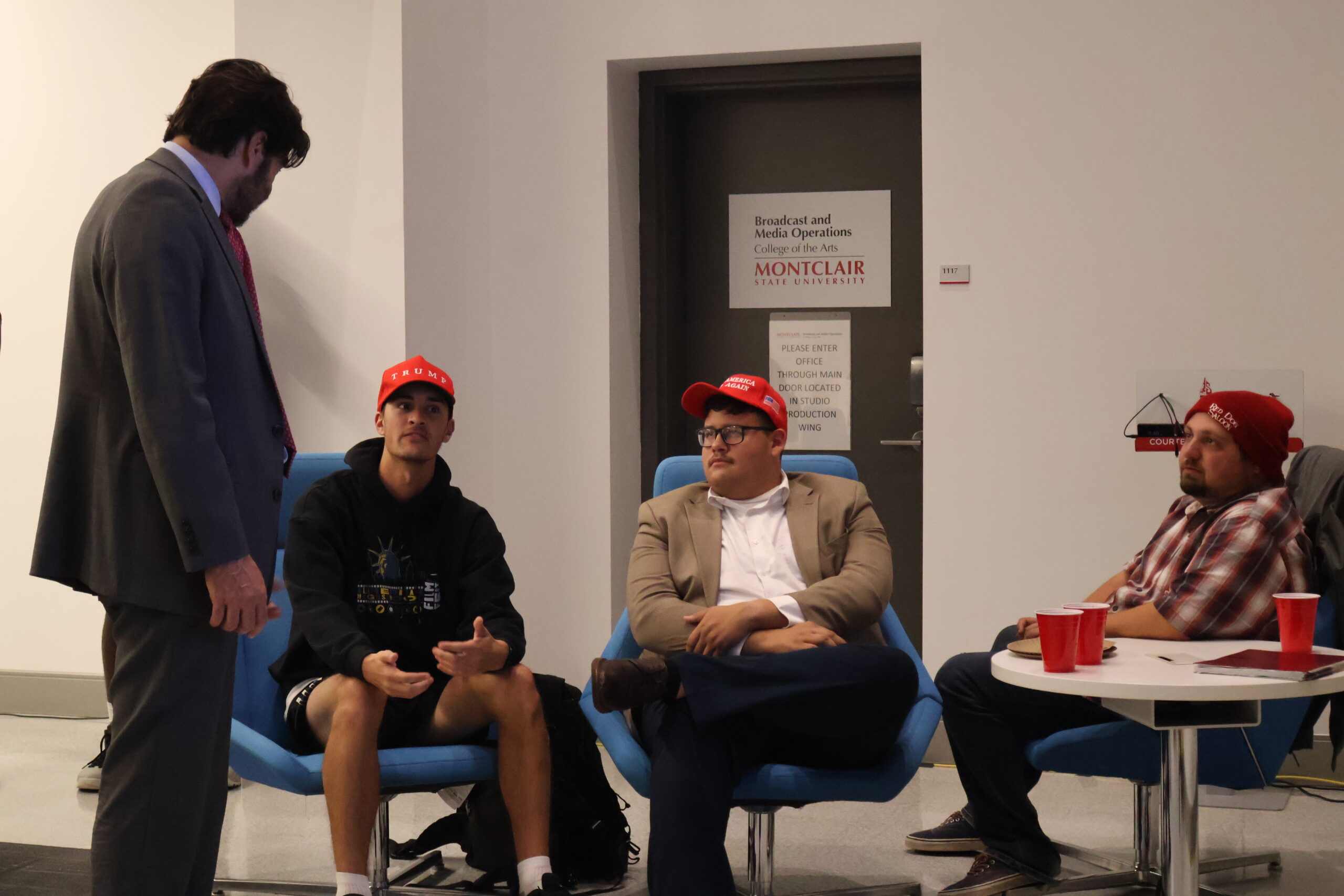 President Koppell speaks with students while watching the election results come in.