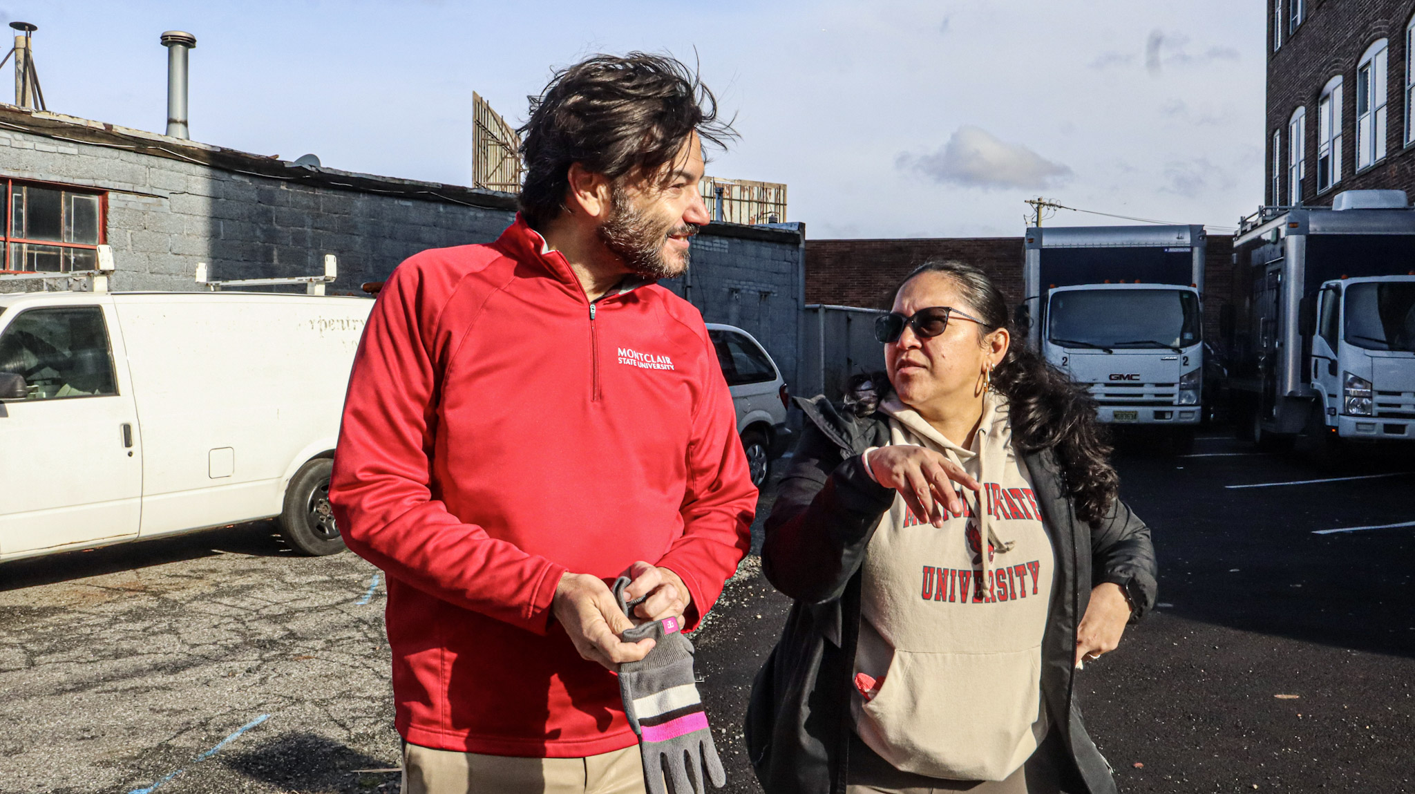 President Koppell in attendance at the turkey delivery event, speaking with one of the volunteer staff members.