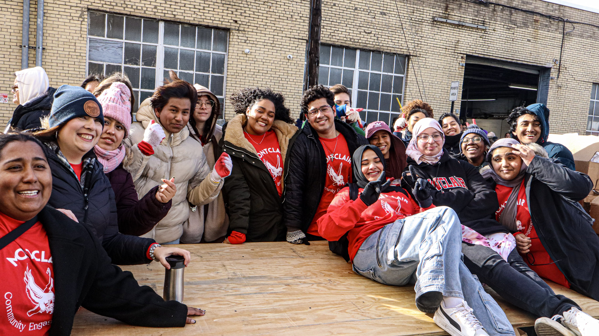 Montclair State's NextGen Service Corps taking a group photo during the Turkey delivery event.