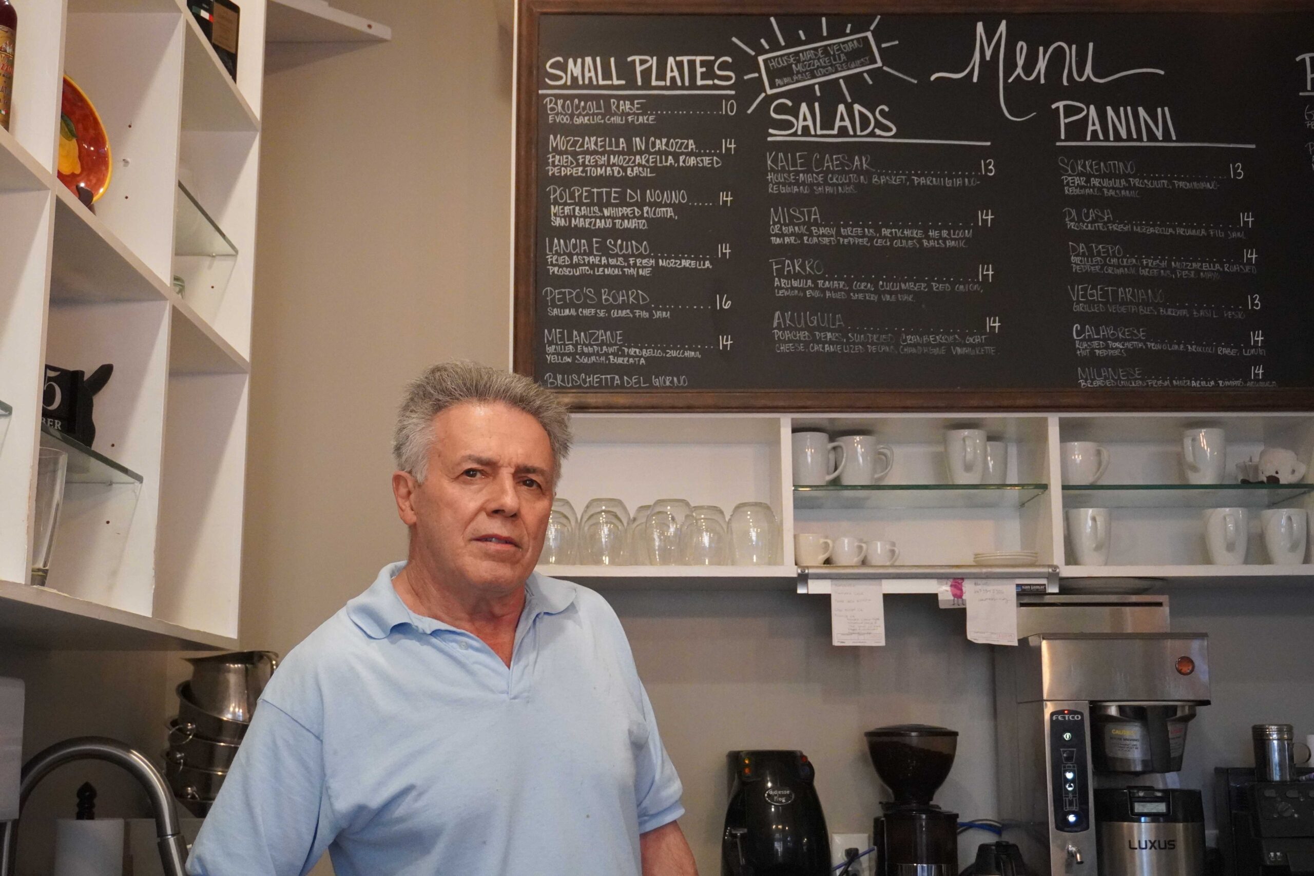 Carlo Orrico, owner and head chef of da Pepo, stands in front of the restaurant's menu. Jordan Reed | The Montclarion