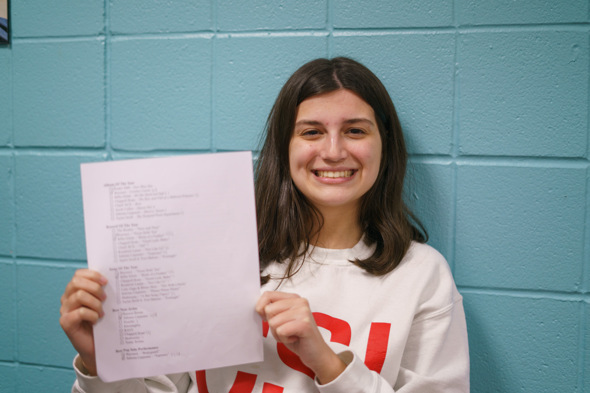 Carmela Beitler, a junior psychology major, poses with her voting sheet